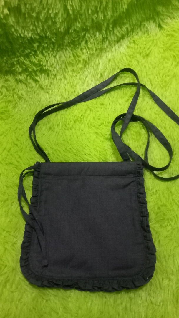 Dark Blue Ruffle Crossbody Bag (Category: Cross-body Bags) located in Manila. Submitted by twinklelyn03 (Listing ID 1421301527, Image 2). Description: - Dark blue fabric - Ruffle trim detail - Long crossbody strap - Simple, open interior - Small and stylish design - Ideal for carrying essentials see photos for details pm sa sure buyer only maraming salamat po!.