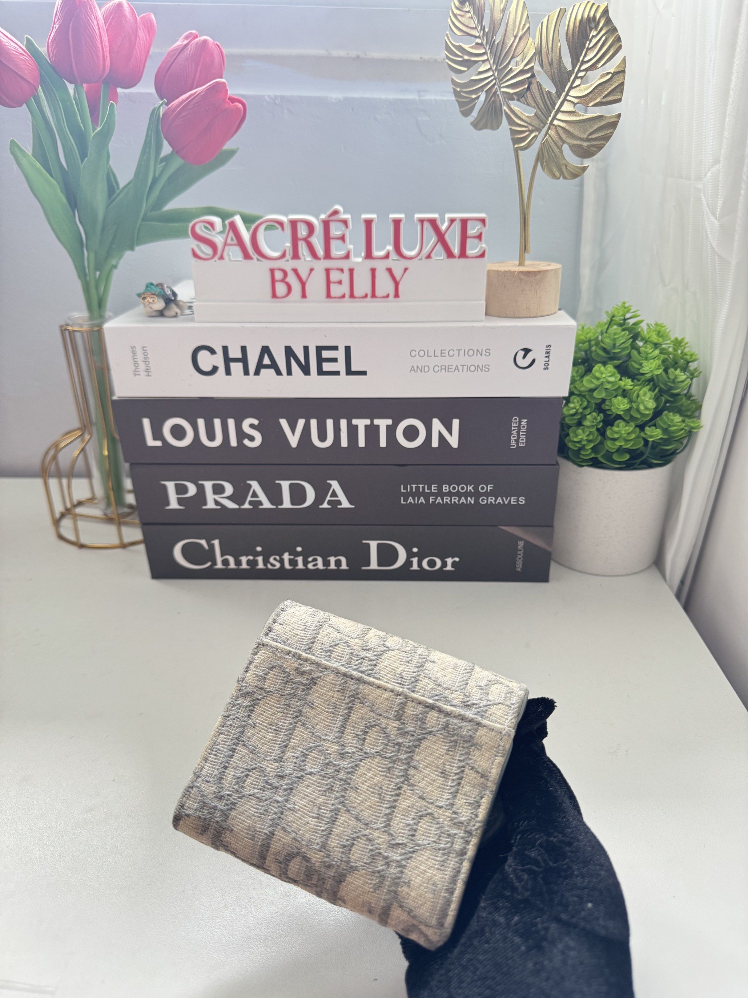 Dior Tri-Fold Wallet (Category: Luxury Bags & Wallets) located in Manila. Submitted by sacreluxebyelly (Listing ID 1421338092, Image 2). Description: - Authentic Dior tri-fold wallet - Iconic Dior Oblique canvas - Snap closure - Gold-tone 'D' charm - Interior: Card slots and zippered coin compartment - Light blue interior - Compact and stylish design.
