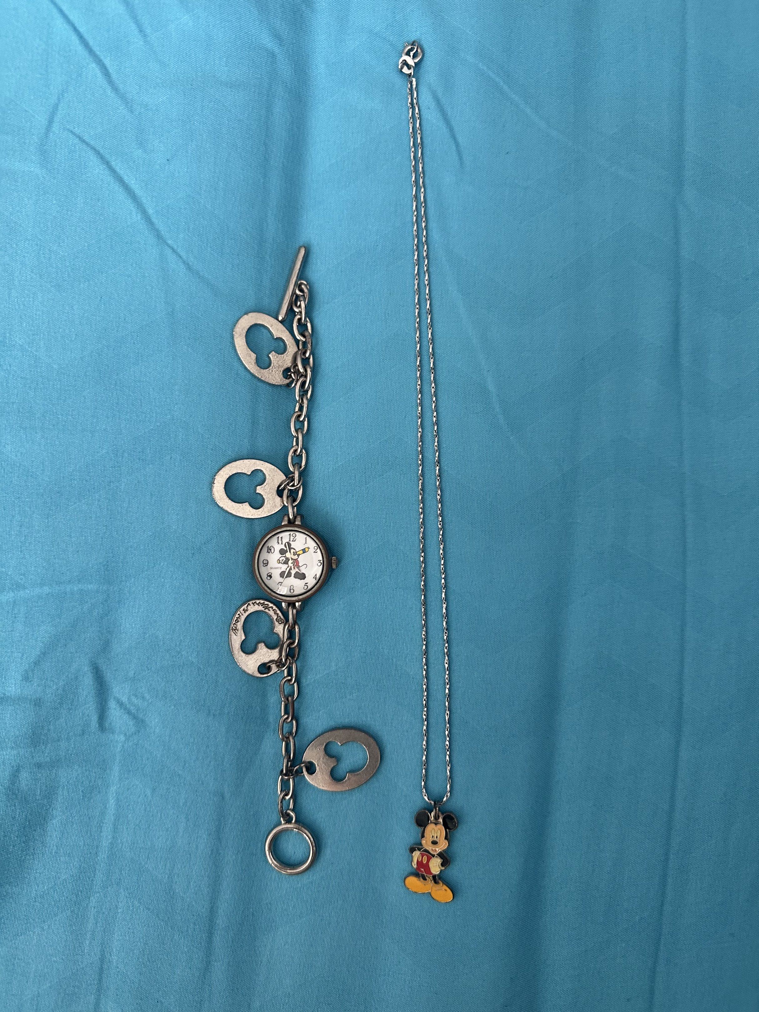 Disney Mickey Mouse Watch and Necklace Set (Category: Necklaces) located in Cainta. Submitted by richter_26 (Listing ID 1421360878, Image 1). Description: - Mickey Mouse watch with Mickey Mouse face and charm details. - Matching necklace with Mickey Mouse pendant. - Both pieces are silver-toned. - Great for Disney enthusiasts! - Bought in Hong Kong .