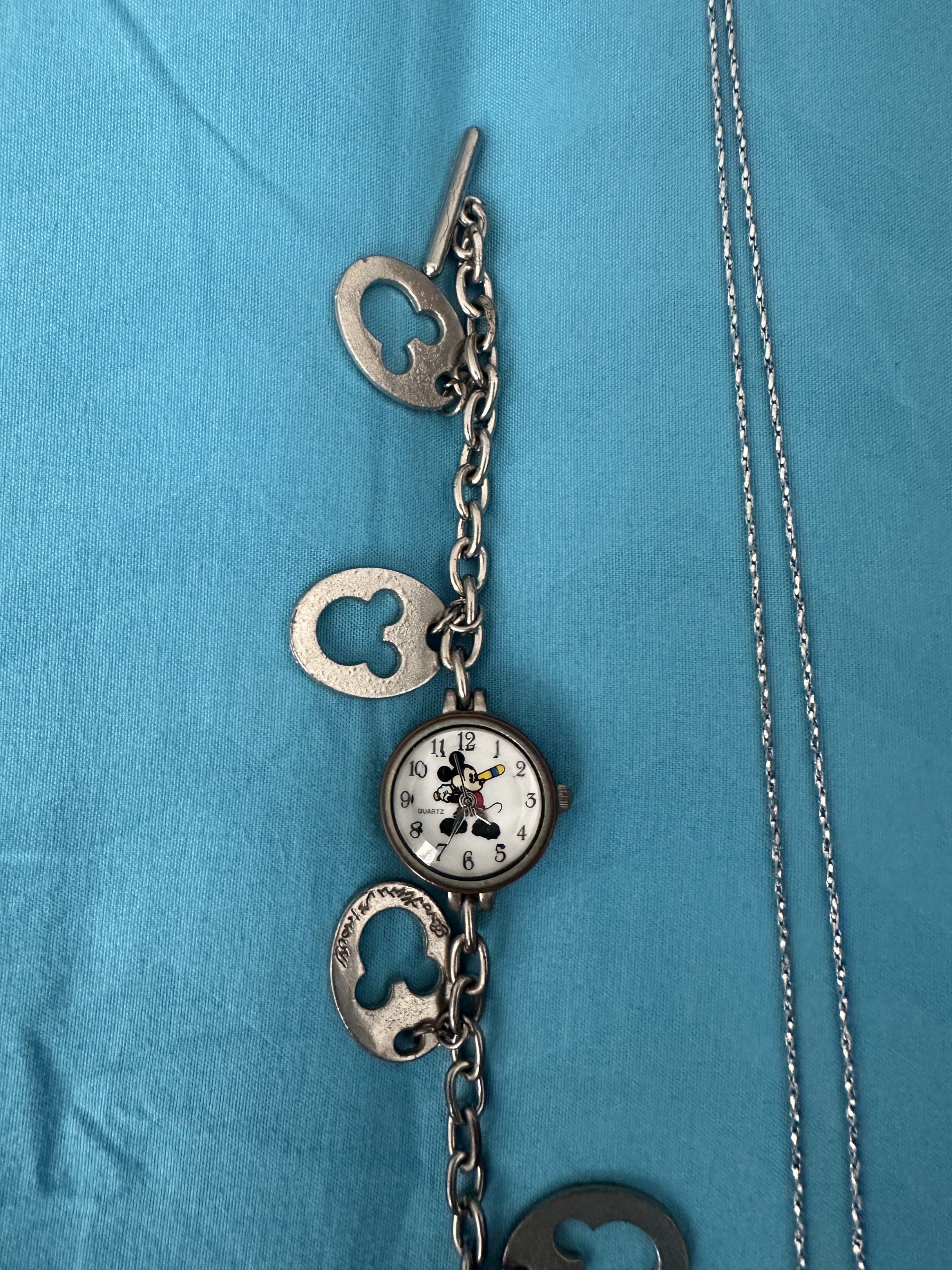 Disney Mickey Mouse Watch and Necklace Set (Category: Necklaces) located in Cainta. Submitted by richter_26 (Listing ID 1421360878, Image 2). Description: - Mickey Mouse watch with Mickey Mouse face and charm details. - Matching necklace with Mickey Mouse pendant. - Both pieces are silver-toned. - Great for Disney enthusiasts! - Bought in Hong Kong .