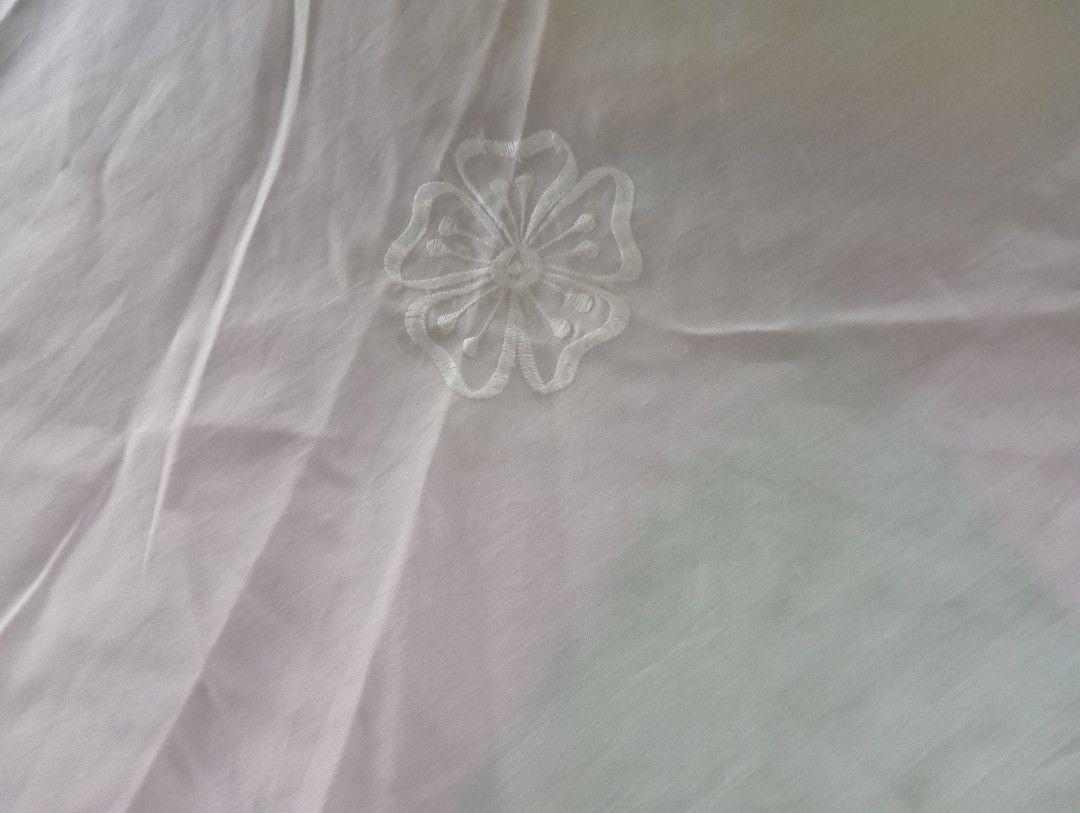 Embroidered Round Tablecloth for 6seater round table (Category: Table Linen & Textiles) located in Dasmarinas. Submitted by kei05 (Listing ID 1421310542, Image 3). Description: - Round tablecloth - Delicate floral embroidery - Scalloped edge with cut-out floral designs - Light, possibly sheer fabric - For round dining tables - Color: White or off-white.