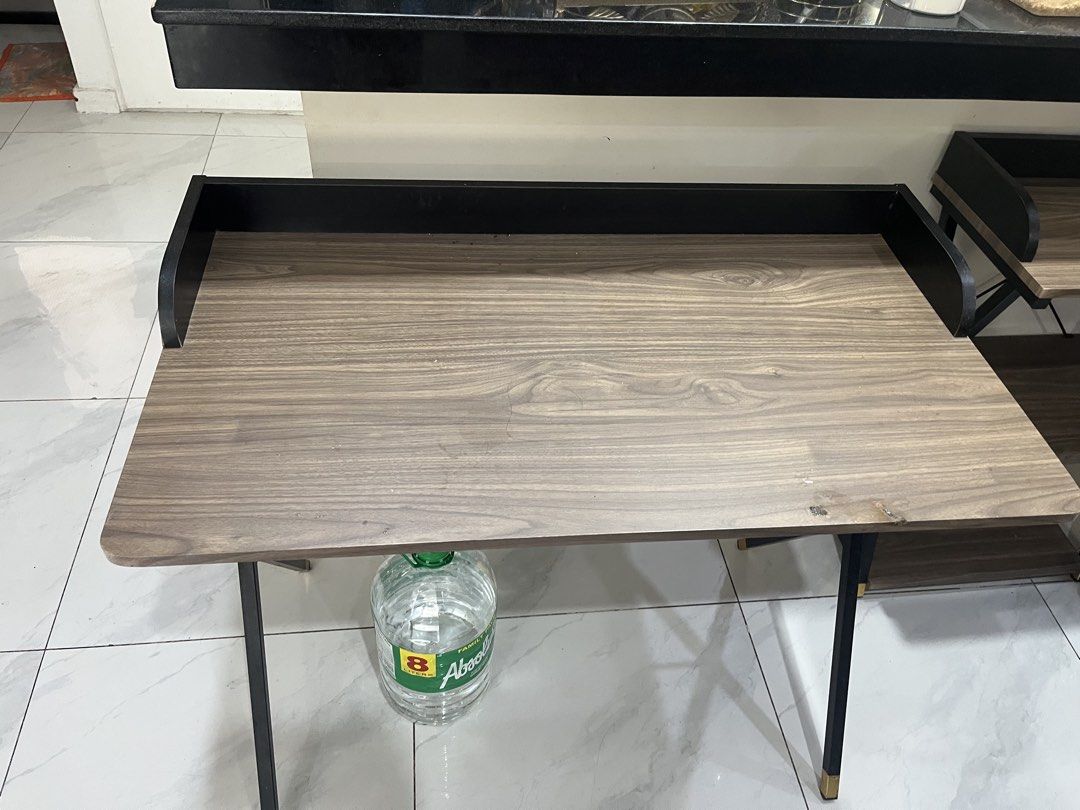 Folding Study Table with Black Frame (Category: Tables & Sets) located in Mandaluyong City. Submitted by ekatipunan.oxychem (Listing ID 1421347457, Image 2). Description: - Wooden top with black frame - Built-in shelf - Gold-colored leg accents - Foldable design for easy storage - Sturdy construction - Perfect for study or work from home.