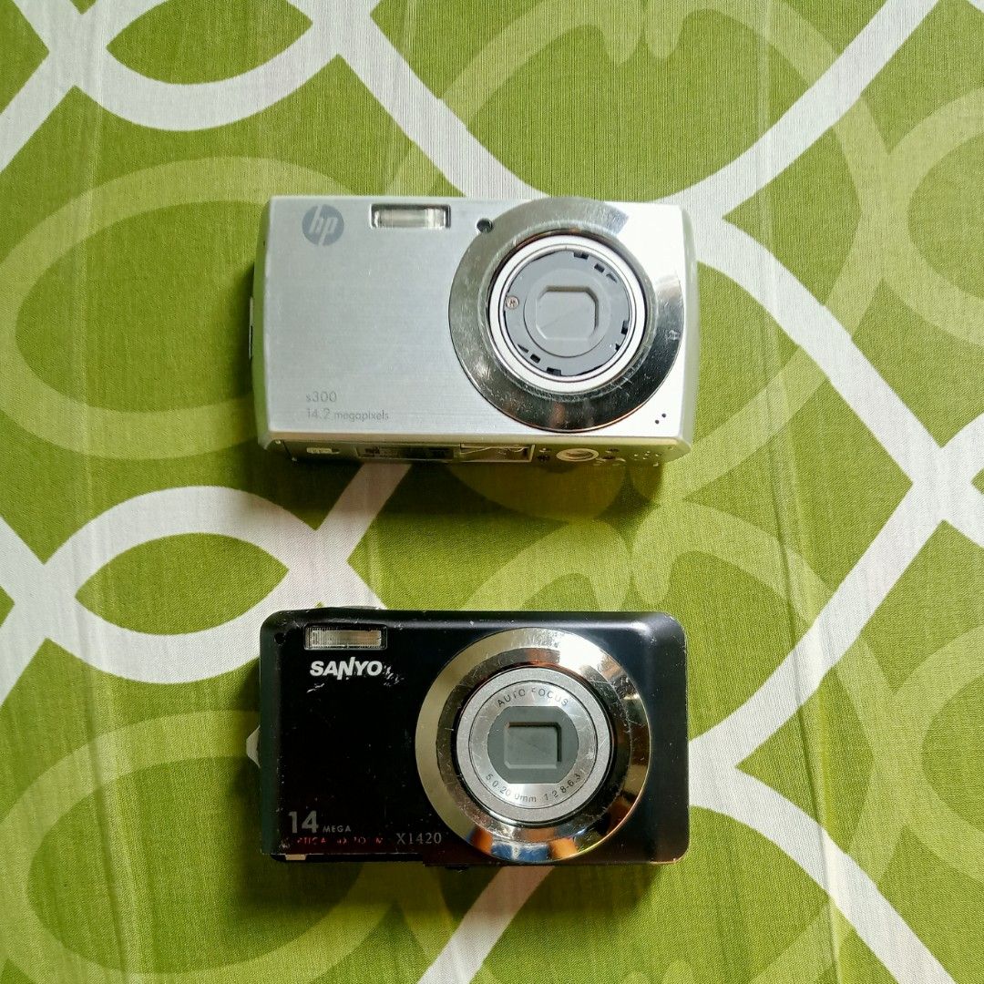 For Repair / Untested / For Parts – Digital Camera Bundle (HP & SANYO) (Category: Cameras) located in Dingras. Submitted by seemybaul (Listing ID 1414878251, Image 1). Description: ❗PLEASE READ❗ These cameras are NOT fully functional and are sold AS-IS for repair, parts, or collectors. 💰 Pricing 💰 • ₱500 – All 2 cameras (HP & Sanyo) + HP battery and charger ❕Please see the individual listings for more photos of each camera and if you wish to pu