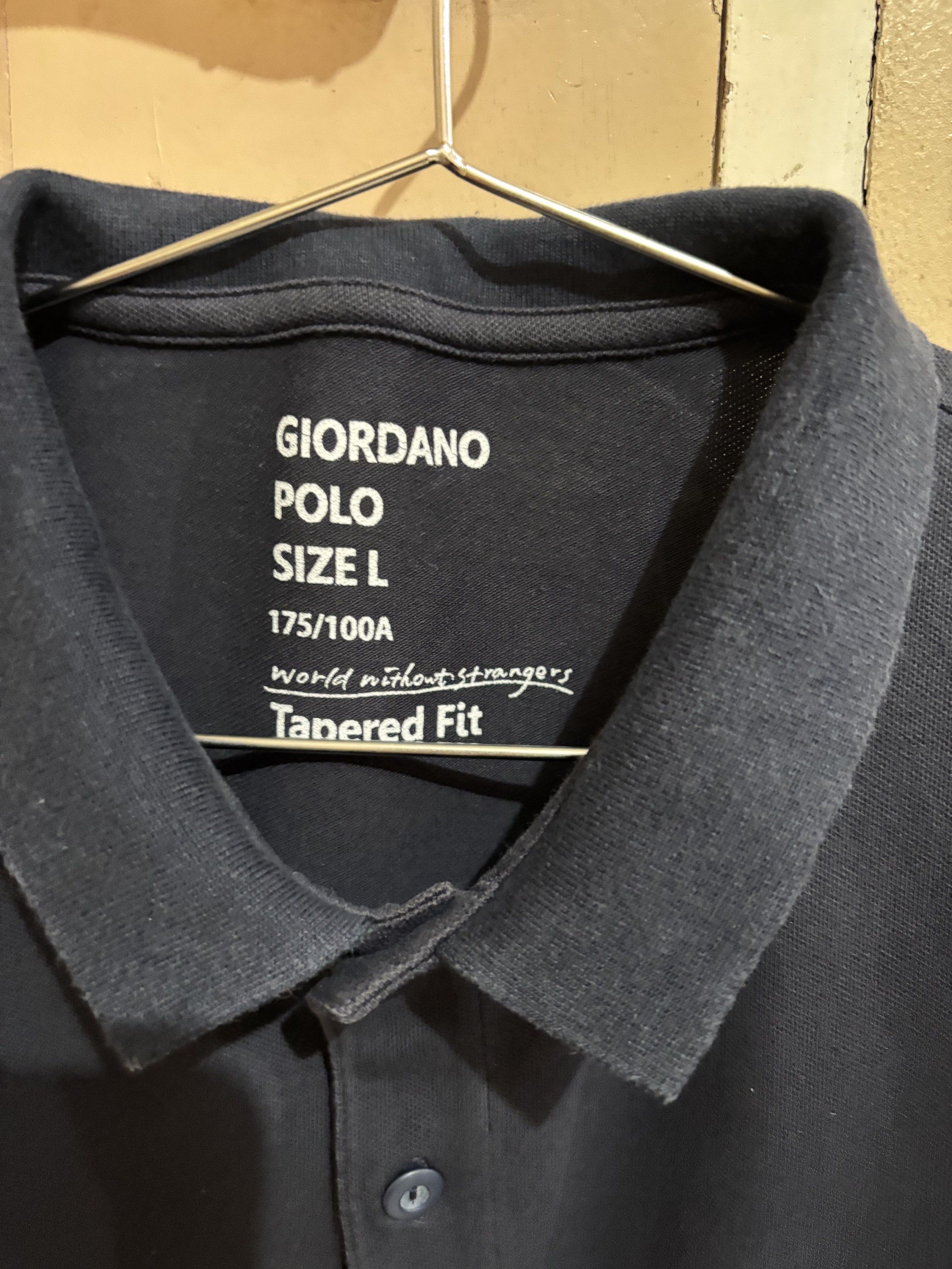 Giordano Polo Shirt - Size L (Category: Tshirts & Polo Shirts ) located in Concepcion. Submitted by cherishedthreads (Listing ID 1421318402, Image 2). Description: - Giordano navy blue polo shirt - Size: L (tapered fit) - Color: Navy blue - Features a green crocodile logo - Striped details on sleeves - Classic polo collar - Button closure - Comfortable fabric.