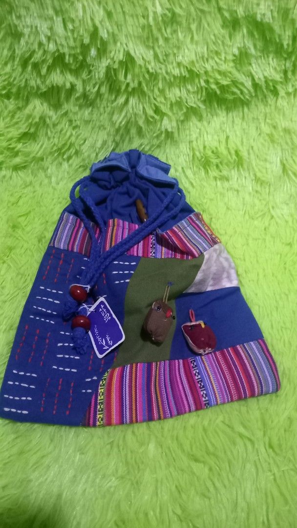 Handmade Patchwork Drawstring Bag (Category: Tote Bags) located in Manila. Submitted by twinklelyn03 (Listing ID 1421302713, Image 1). Description: - Handmade drawstring bag - Colorful patchwork design on one side - Solid blue fabric on the other side - Drawstring closure with wooden beads - Includes a small tag - Ideal for carrying small items - Stylish and practical accessory see photos for details pm sa sure buyer only maraming salamat po!.