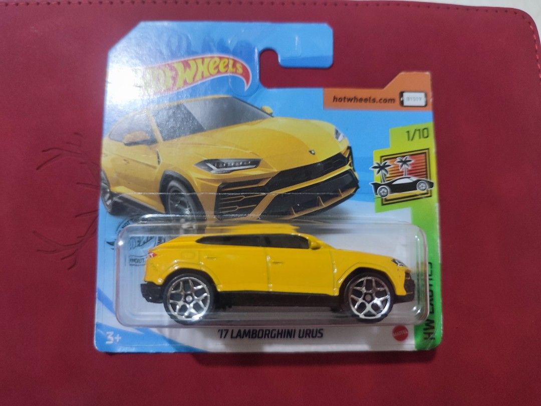 Hot Wheels '17 Lamborghini Urus (Category: Vehicle & Diecast Models) located in Narvacan. Submitted by jigger85 (Listing ID 1421402323, Image 1). Description: - Hot Wheels '17 Lamborghini Urus diecast car. - Yellow SUV with black accents. - Part of the 1/10 series. - Comes in original packaging. - Packaging features a blue and green color scheme..