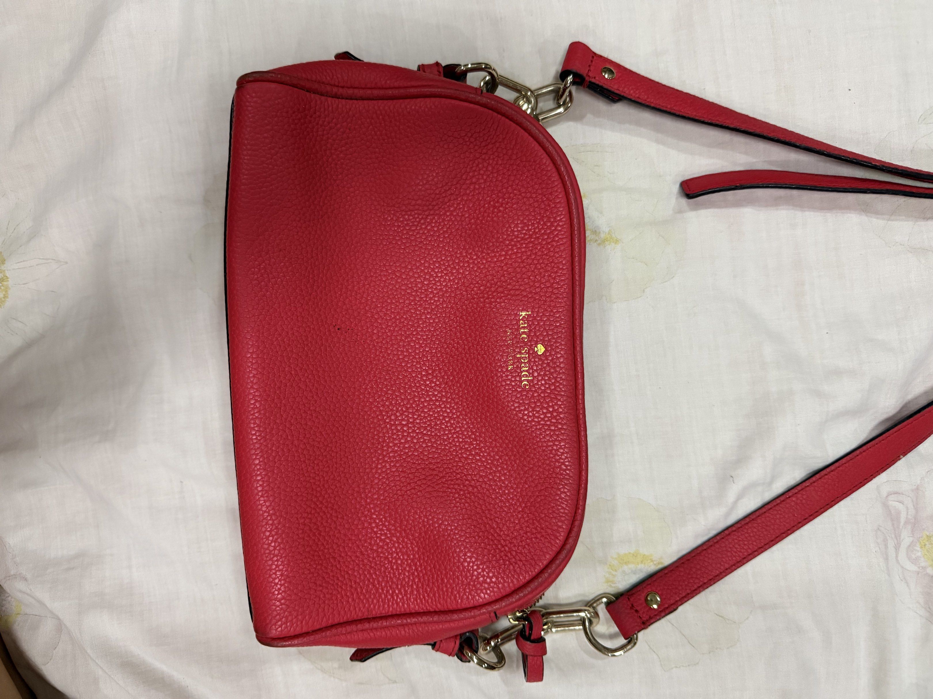 Kate Spade Red Crossbody Bag (Category: Cross-body Bags) located in Quezon City. Submitted by chasy9 (Listing ID 1421419385, Image 1). Description: - Authentic Kate Spade crossbody bag - Features a double-zippered main compartment and an adjustable strap - Includes a Kate Spade care card - The strap shows some wear, as shown in photo.