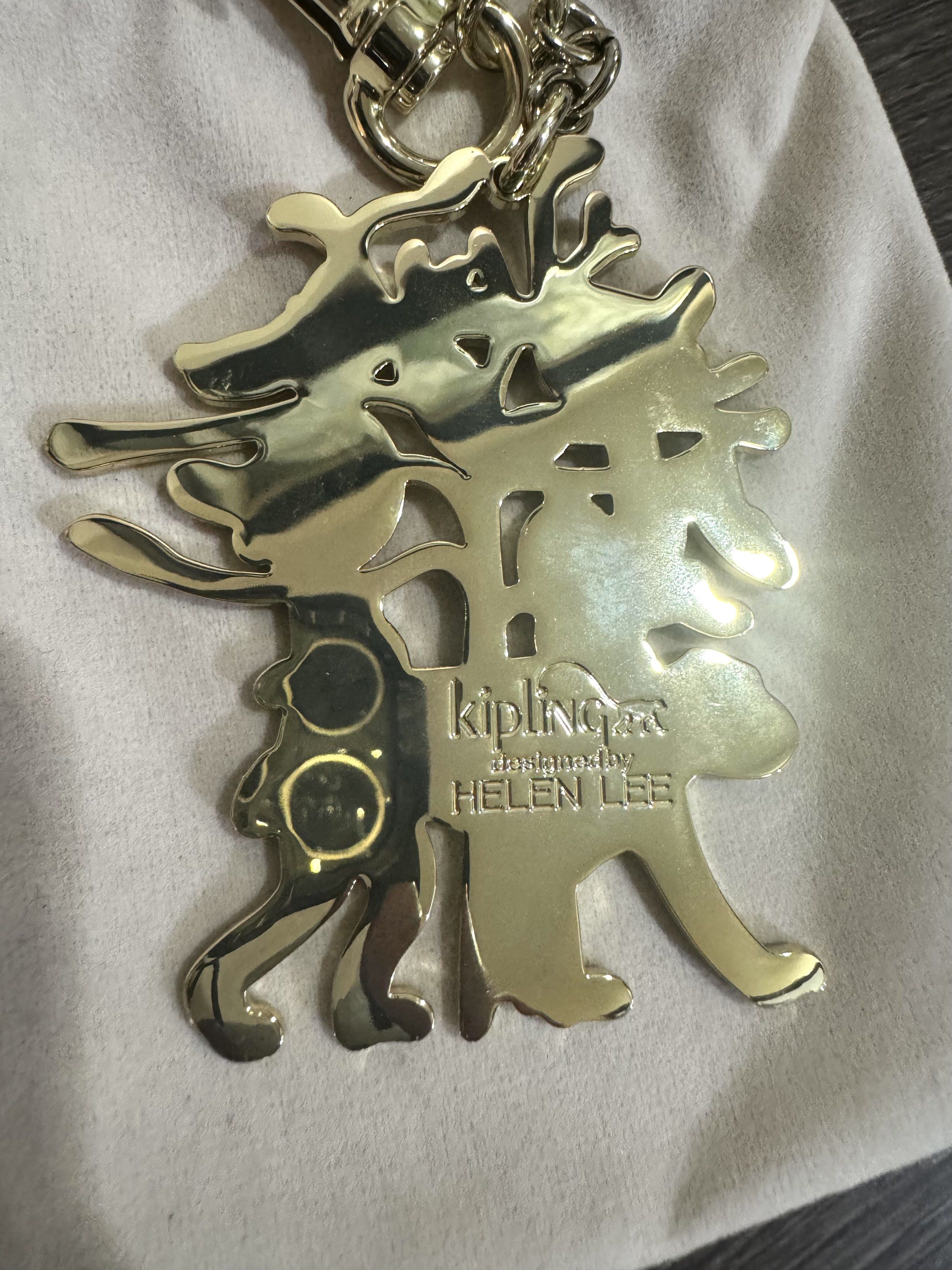 Kipling Helen Lee Monkey Wish Tree keychain (Category: Other Accessories) located in Davao. Submitted by pilmarmustdeclutter (Listing ID 1421362001, Image 3). Description: - Kipling Helen Lee key hanger - Features a fun monkey design with bananas - Includes a gold-tone clasp and beige pouch - New with tags - Kipling logo and Helen Lee's name on the back P1500 excluding sf.