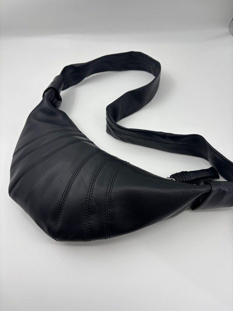 LEMAIRE Croissant Bag - Black (Category: Sling Bags) located in Caloocan City. Submitted by rossvault2 (Listing ID 1421336821, Image 1). Description: - Lemaire shoulder bag small - Black color - Distinctive croissant shape - Single shoulder strap - Secure zipper closure - Fabric interior - Features a small leather tag with brand details - Made in Spain -missing white tag.