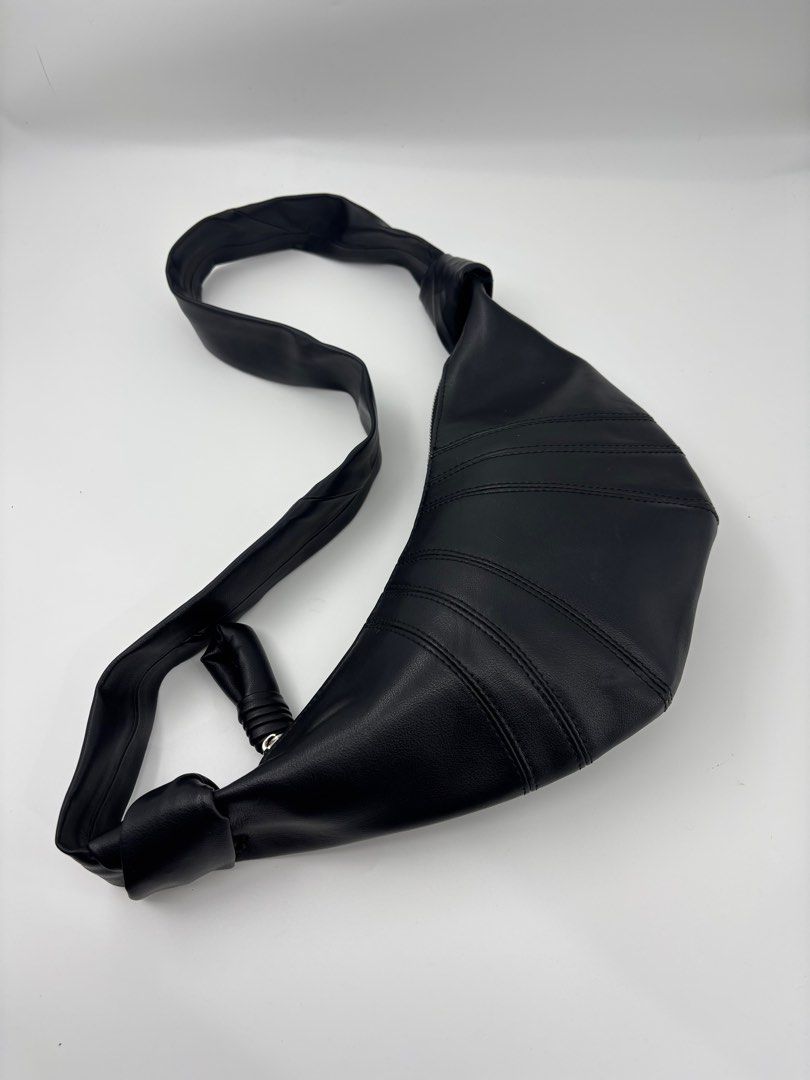 LEMAIRE Croissant Bag - Black (Category: Sling Bags) located in Caloocan City. Submitted by rossvault2 (Listing ID 1421336821, Image 2). Description: - Lemaire shoulder bag small - Black color - Distinctive croissant shape - Single shoulder strap - Secure zipper closure - Fabric interior - Features a small leather tag with brand details - Made in Spain -missing white tag.