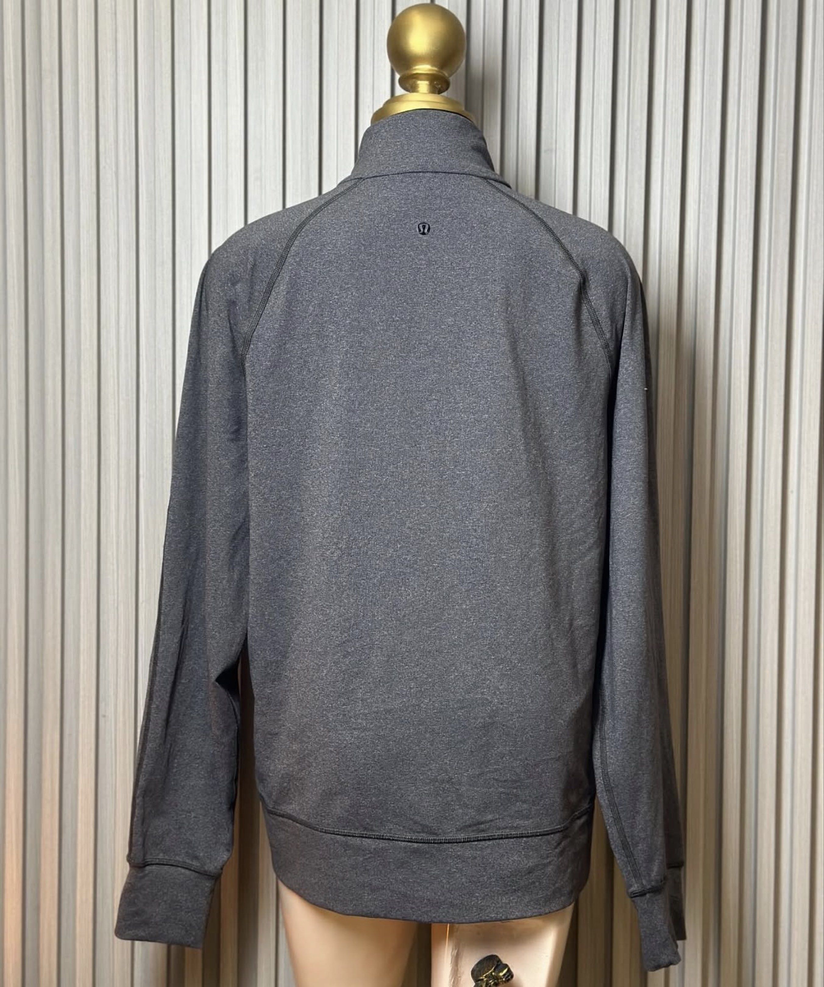 Lululemon Full Zip Jacket - Large (Category: Activewear) located in Naga. Submitted by ubi04 (Listing ID 1421371415, Image 2). Description: - Lululemon full zip jacket - Color: Gray and black - Size: Large - Features: - High collar - Front pockets - Thumb holes - White zipper - Lululemon logo on back - Measurements: - Chest: 22.5" - Length: 28".