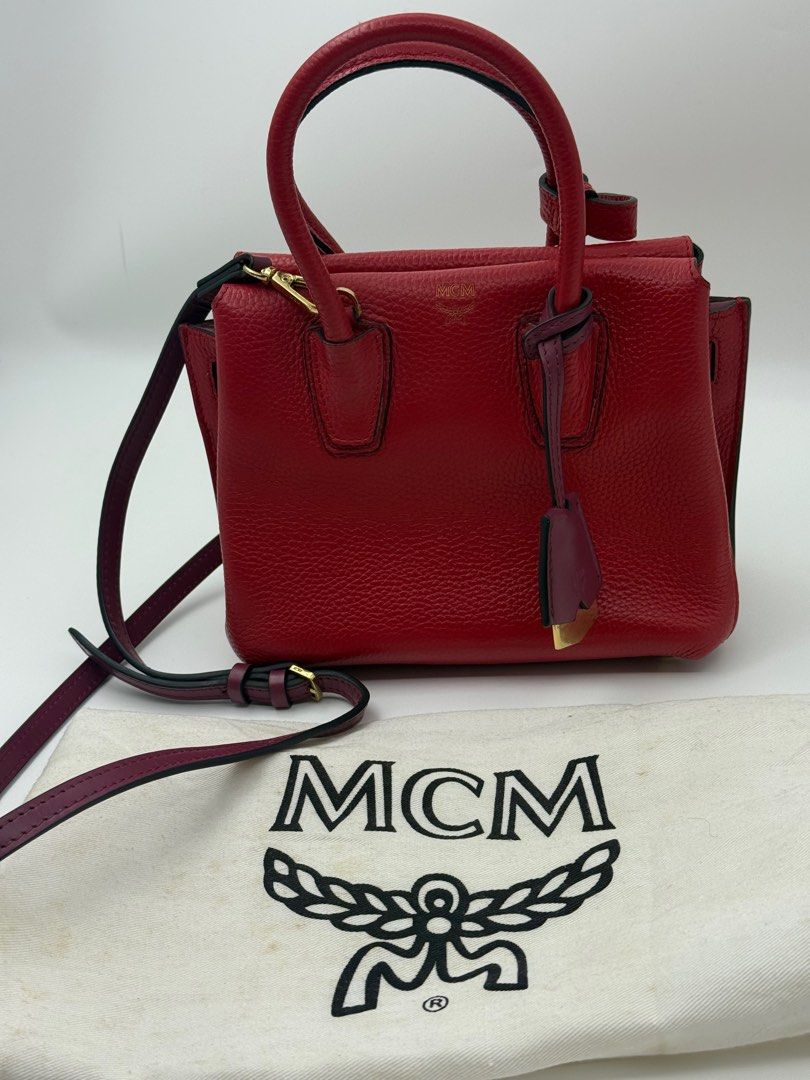 MCM Red Handbag with Shoulder Strap (Category: Luxury Bags & Wallets) located in Caloocan City. Submitted by rossvault2 (Listing ID 1421324687, Image 3). Description: Red handbag from MCM features a top handle and a detachable shoulder strap. It has a structured design with a flap closure. The bag includes gold-tone hardware and a matching dust bag. Authentic Ykk zip Normal signs of use With dustbag.