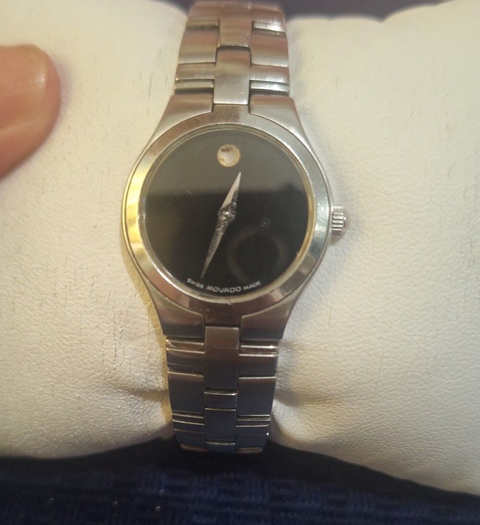 Movado Swiss Made Watch (Category: Women's Watches) located in Manila. Submitted by cor1024 (Listing ID 1421326617, Image 3). Description: - Movado watch - Black dial - Silver-tone stainless steel bracelet - Minimalist design - Single dot at 12 o'clock - Round face - Secure clasp - Swiss made.