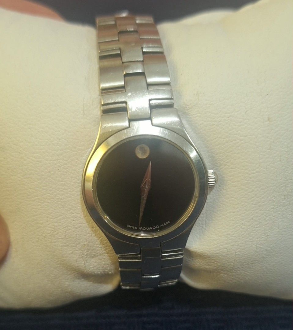 Movado Swiss Made Watch (Category: Women's Watches) located in Manila. Submitted by cor1024 (Listing ID 1421326617, Image 1). Description: - Movado watch - Black dial - Silver-tone stainless steel bracelet - Minimalist design - Single dot at 12 o'clock - Round face - Secure clasp - Swiss made.