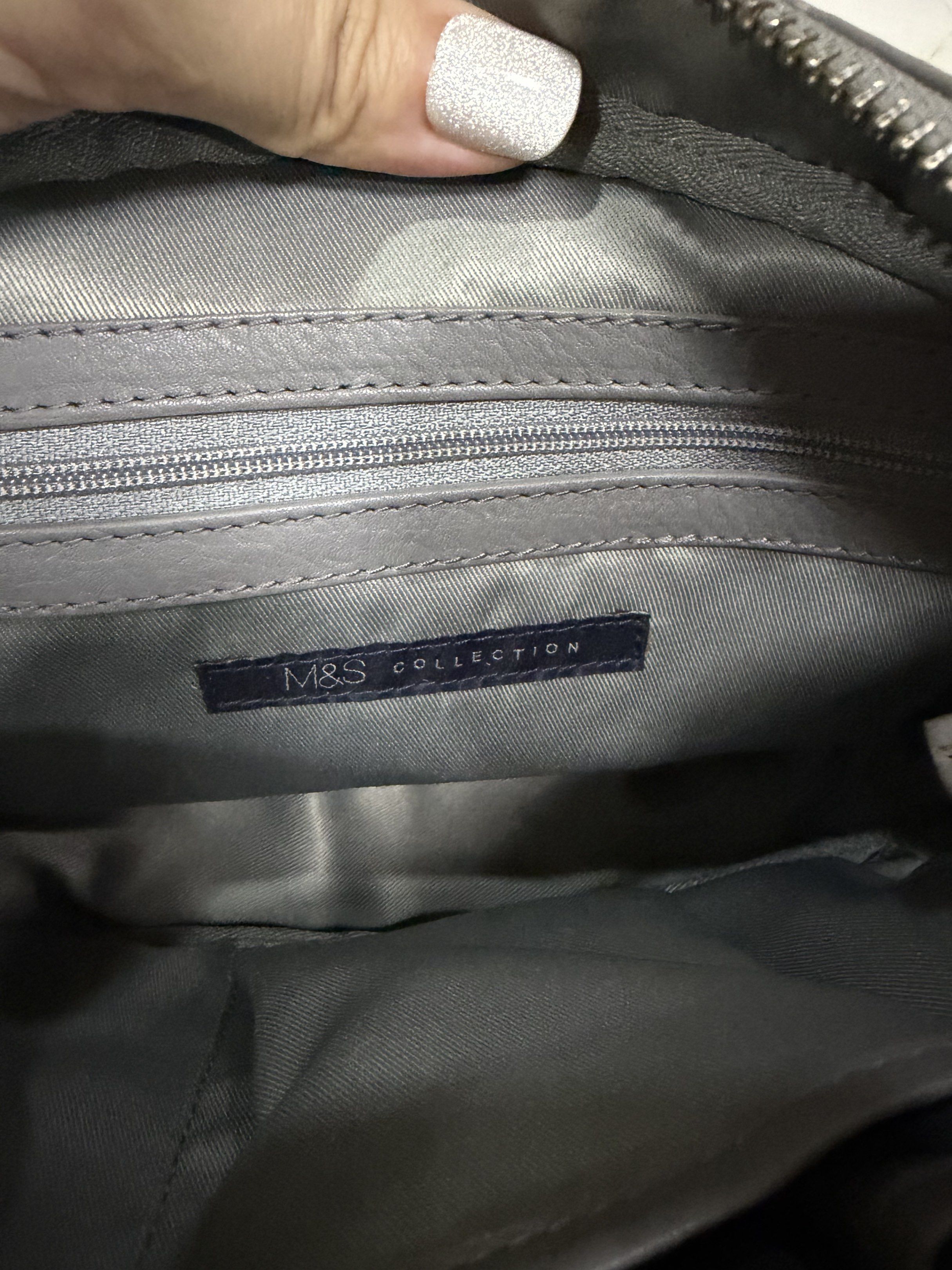 M&S Collection Quilted Crossbody Bag (Category: Cross-body Bags) located in Quezon City. Submitted by chasy9 (Listing ID 1421420018, Image 3). Description: - Gray crossbody bag from M&S Collection - Features a quilted design on the front and a chain detail on the sides - The bag has a zippered main compartment and an interior pocket - Includes an adjustable strap. Slight wear on the straps as shown in photo - Leather is still in very good conditi