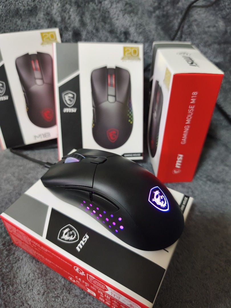 MSI M18 Gaming Mouse (Category: Mouse & Mousepads) located in Pasay City. Submitted by nanotechno11 (Listing ID 1421312368, Image 1). Description: MSI gaming mouse M18 Limited Edition 20th Anniversary Specifications: Resolution: 5000DPI(max) Accelaration: 20g Switch Life: 80 million times Power Supply: 5V – 500mA Connection Type: Wired. 2.4G. BLE Weight: 116g Size: 131 x 76 x x 43mm RGB LED: Yes – Diamond-shaped RGB lighting grip design Battery s