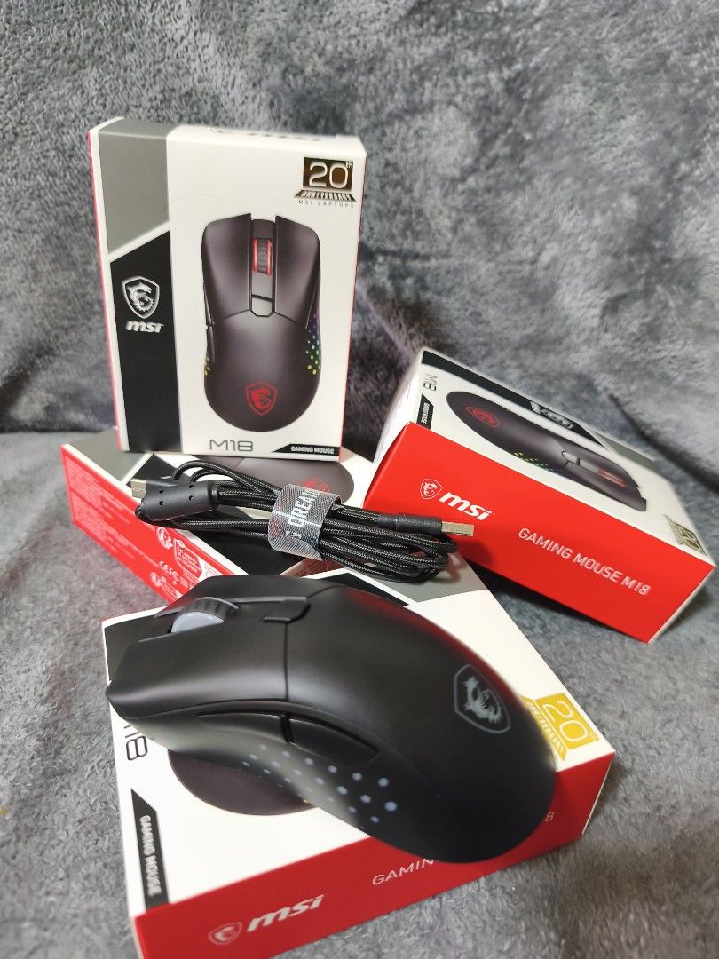 MSI M18 Gaming Mouse (Category: Mouse & Mousepads) located in Pasay City. Submitted by nanotechno11 (Listing ID 1421312368, Image 2). Description: MSI gaming mouse M18 Limited Edition 20th Anniversary Specifications: Resolution: 5000DPI(max) Accelaration: 20g Switch Life: 80 million times Power Supply: 5V – 500mA Connection Type: Wired. 2.4G. BLE Weight: 116g Size: 131 x 76 x x 43mm RGB LED: Yes – Diamond-shaped RGB lighting grip design Battery s