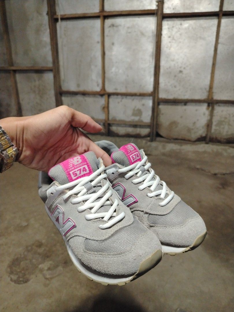 New Balance 574 Gray Pink Sneakers (Category: Sneakers) located in Midsalip. Submitted by shoesselector (Listing ID 1421383849, Image 2). Description: ✅For more details🗣️🗣️🗣️👟👟 ✅You can chat me or Make an offer New Balance 574 sneakers in gray and pink. Features the iconic 'N' logo on the sides. The size is EU 37.5. The shoes have white laces and a white sole. The heel area has the New Balance logo. The inner lining is pink..
