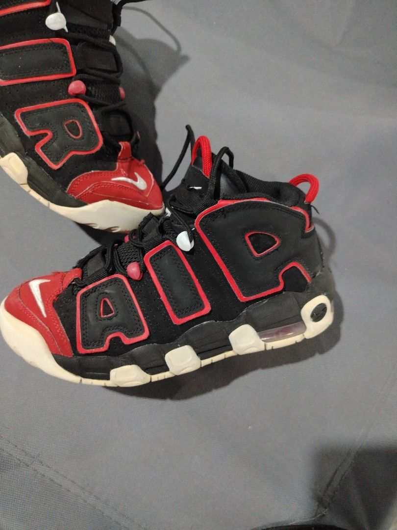 Nike Air More Uptempo Black Red (Category: Sneakers) located in Midsalip. Submitted by shoesselector (Listing ID 1421397190, Image 3). Description: Nike Air More Uptempo sneakers in black and red. Features the iconic "AIR" branding on the sides. The shoes have a black base with red accents and a white sole. The Nike swoosh logo is visible on the toe and heel. The size is US 5Y, UK 4.5, EUR 37.5, and CM 23.5..