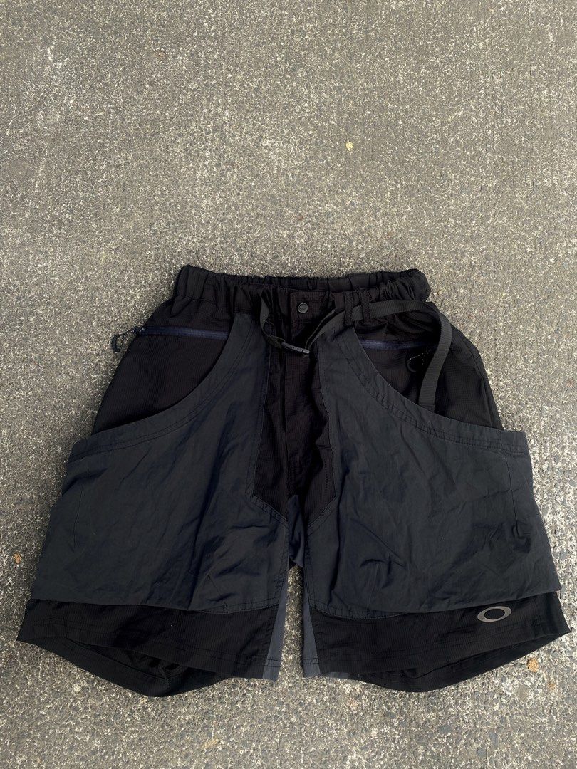 Oakley Software Black Cargo Utility Shorts XL (Category: Shorts) located in General Trias. Submitted by tuffstuff13 (Listing ID 1421389474, Image 1). Description: - Width (Elastic waistband/free waist) - Length 19 - Black Oakley software cargo utility shorts (XL) - Durable, textured fabric - Multiple pockets for storage - Built-in belt and elastic waistband for comfort - Button closure and drawstring - Unique design with overlapping panels - Oakl