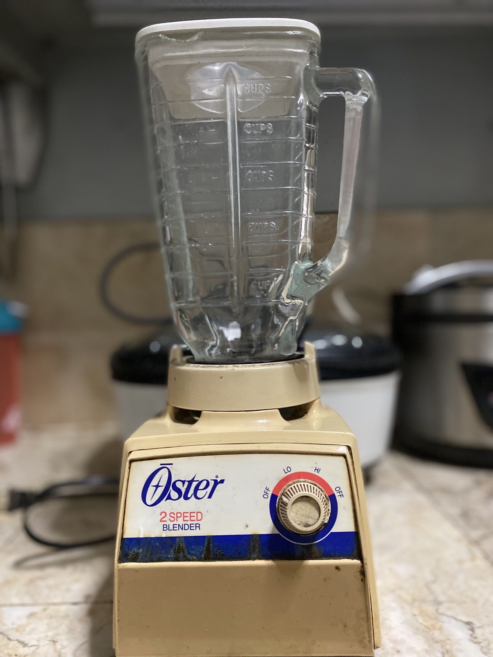 Oster 2-Speed Blender (Category: Juicers, Blenders & Grinders) located in Pasig City. Submitted by ecochicsales (Listing ID 1421306716, Image 1). Description: Oster 2-speed blender with a glass pitcher. Features a dial for low and high speeds. The pitcher has measurement markings. The blender's base is beige. Perfect for making smoothies and other blended drinks..
