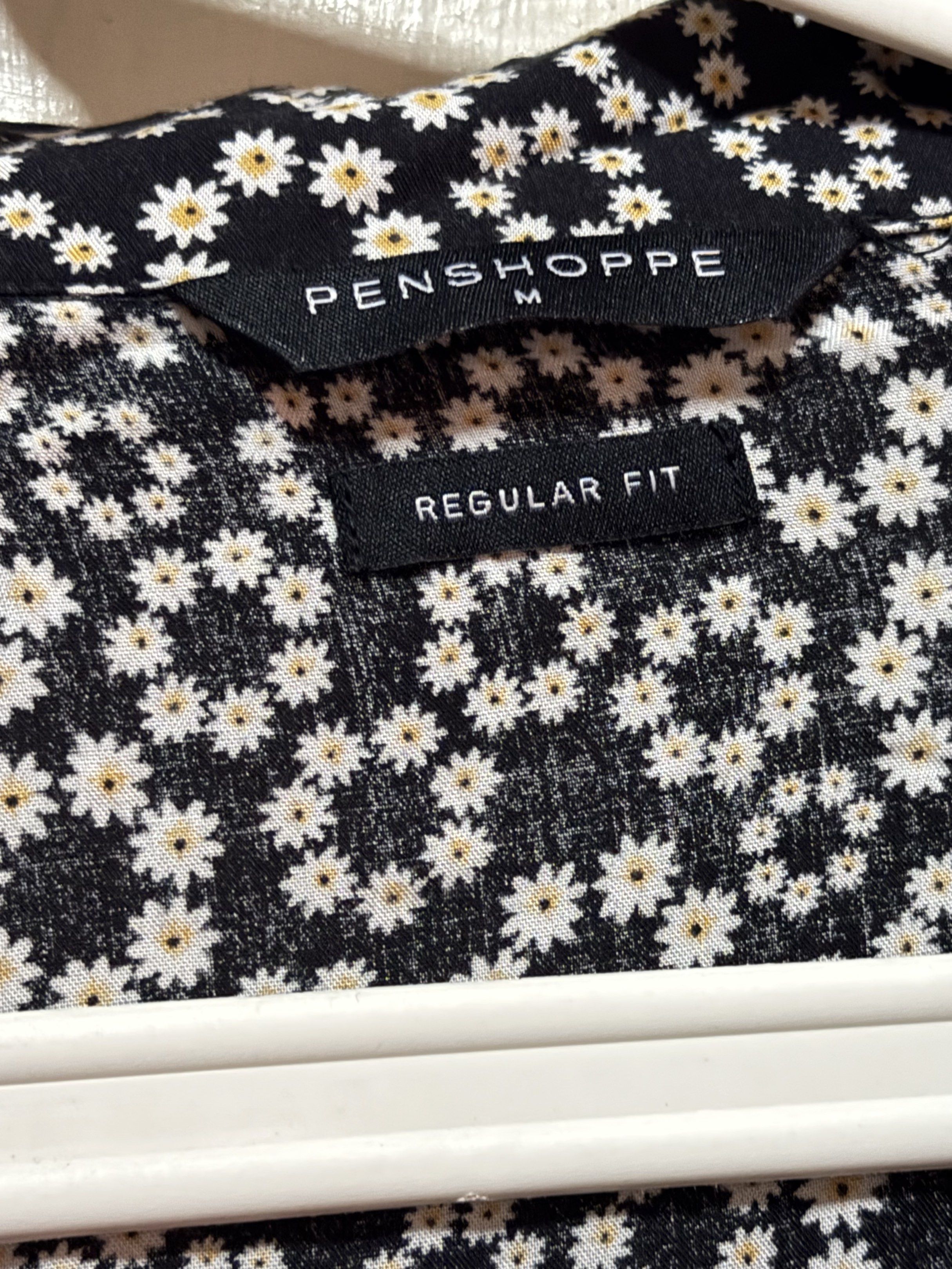 Penshoppe Floral Dress - Medium (Category: Dresses) located in Las Pinas. Submitted by gelds (Listing ID 1421348703, Image 3). Description: - Penshoppe dress - Black base with white floral pattern - Short sleeves - Button-down front - V-neckline - Regular fit - Lightweight fabric.