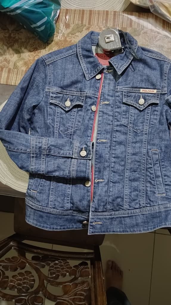Polham Denim Jacket (Category: Coats, Jackets and Outerwear) located in Kota Kinabalu. Submitted by errduhh (Listing ID 1421351621, Image 2). Description: pit - 19 labuh - 25 - Polham denim jacket - Classic design - Button closures - Multiple pockets - Red stripe detail - Standard fit - Suitable for casual wear - Made of denim.