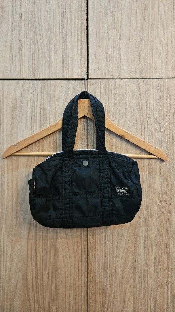 Porter Yoshida & Co. Black Tote Bag (Category: Tote Bags) located in Alfonso. Submitted by jbcamet (Listing ID 1421401098, Image 1). Description: - Black tote bag from Porter-Yoshida & Co. - Top zipper closure - Bright orange interior - Small exterior pocket with snap closure - Two handles for carrying - Durable material (possibly nylon) - Porter-Yoshida & Co. label inside.