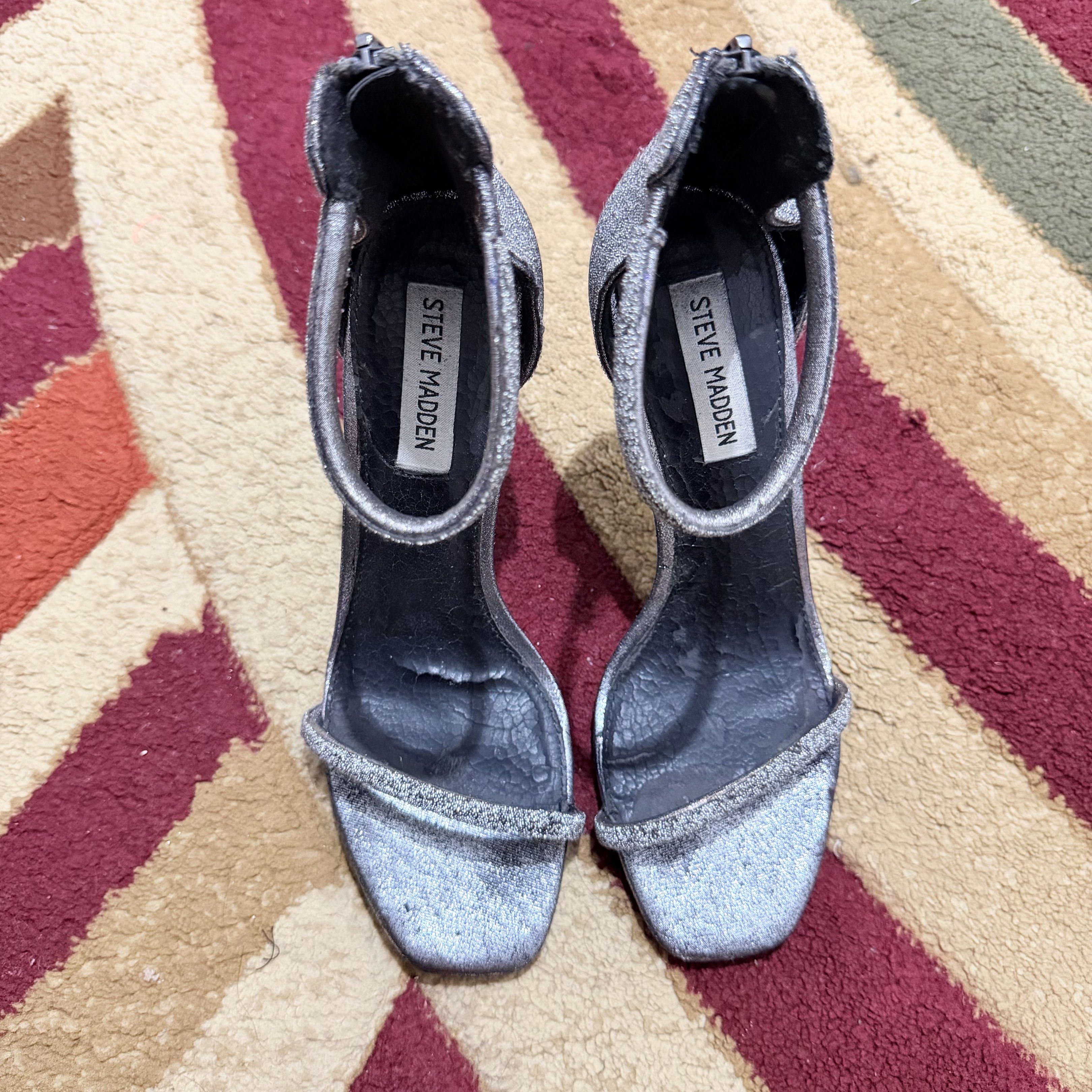 Steve Madden Rapture C Heels - Silver (glitter) (Category: Heels) located in Manila. Submitted by declutternclutter (Listing ID 1421303044, Image 2). Description: Steve Madden Rapture C heels Color: Silver Size: 8 - Ankle strap, toe strap, back zipper - Authentic ✨ - Though you can see it’s well used - Still perfectly serves its purpose - About 4.5 inches high Women’s size US 8 (24.5 cm - 25 cm feet) Original Price: ₱4,950.