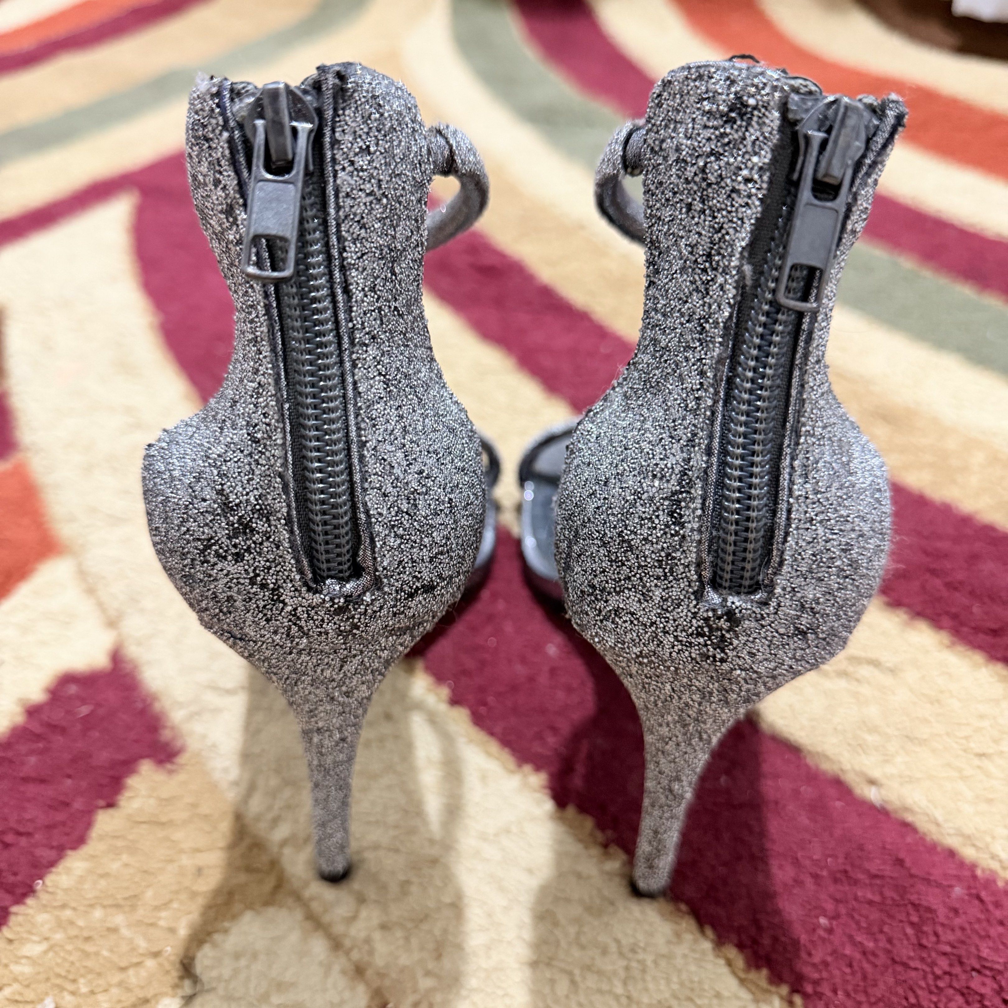 Steve Madden Rapture C Heels - Silver (glitter) (Category: Heels) located in Manila. Submitted by declutternclutter (Listing ID 1421303044, Image 3). Description: Steve Madden Rapture C heels Color: Silver Size: 8 - Ankle strap, toe strap, back zipper - Authentic ✨ - Though you can see it’s well used - Still perfectly serves its purpose - About 4.5 inches high Women’s size US 8 (24.5 cm - 25 cm feet) Original Price: ₱4,950.