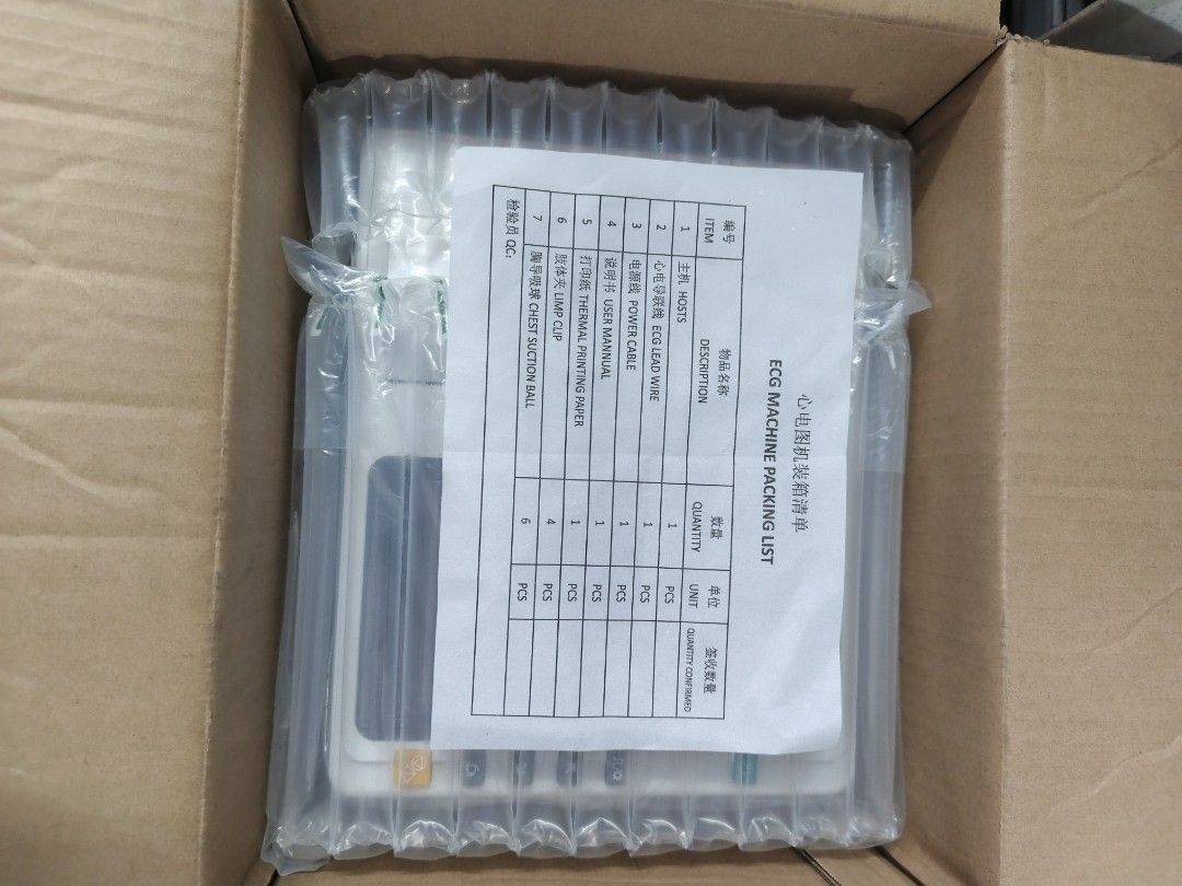 Surrmed ECG Machine 3 Channel (Category: Medical Supplies & Tools) located in Quezon City. Submitted by medicsupplies_09 (Listing ID 1421368959, Image 3). Description: Surrmed ECG Machine MTCECG388. Includes ECG lead wire, power cable, user manual, thermal printing paper, limb clip, and chest suction ball. Made in Germany. The machine has a screen and a paper output. The packing list shows the included items. The machine is in its original packag