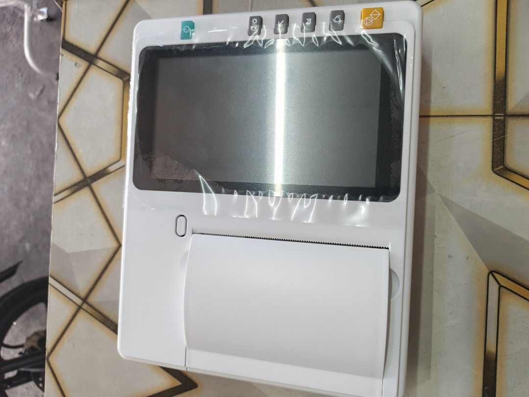 Surrmed ECG Machine 3 Channel (Category: Medical Supplies & Tools) located in Quezon City. Submitted by medicsupplies_09 (Listing ID 1421368959, Image 1). Description: Surrmed ECG Machine MTCECG388. Includes ECG lead wire, power cable, user manual, thermal printing paper, limb clip, and chest suction ball. Made in Germany. The machine has a screen and a paper output. The packing list shows the included items. The machine is in its original packag