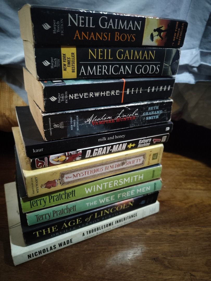 [TAKE ALL] 11 BOOKS FOR 2,000 - 200 each (Category: Storybooks) located in Dasmarinas. Submitted by cacailin (Listing ID 1421360125, Image 2). Description: Collection of assorted paperback books including titles by Neil Gaiman, Terry Pratchett, and others. Titles include "Anansi Boys", "American Gods", "Neverwhere", "Abraham Lincoln: Vampire Hunter", "milk and honey", "D.Gray-Man", "The Mysterious Benedict Society", "Wintersmith", "The Wee Free M