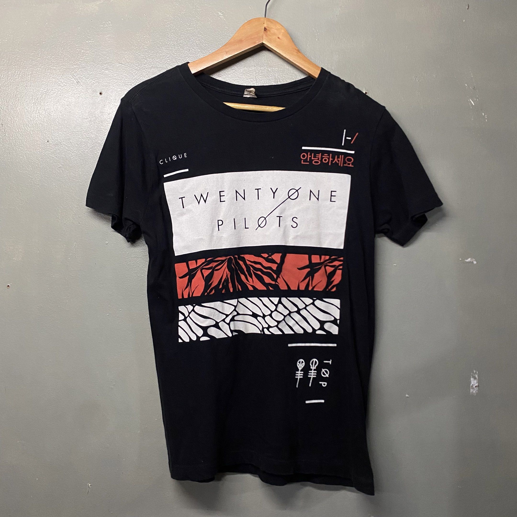Twenty One Pilots Clique T-shirt (Category: Tshirts & Polo Shirts ) located in Cagayan de Oro. Submitted by sumamestreethub (Listing ID 1421341498, Image 1). Description: - Black Twenty One Pilots t-shirt - Features band name and logo graphic - Short sleeves - Crew neck - Plain black back - Tag visible in photos.