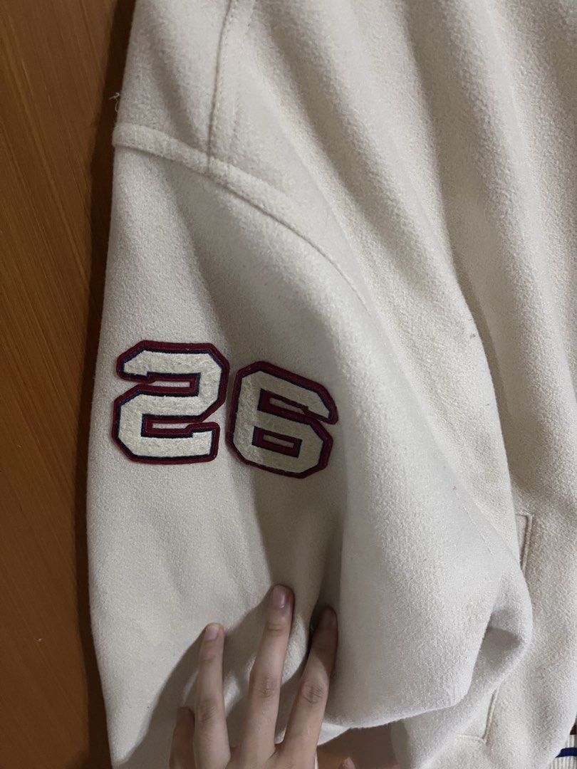 Varsity Jacket with 'S' Patch (Category: Coats, Jackets and Outerwear) located in Singapore. Submitted by lololol.cloud (Listing ID 1421423708, Image 3). Description: - Cream-colored varsity jacket - Features a large 'S' patch - '26' on the sleeve - Striped collar, cuffs, and hem - Snap button closure - Perfect for a casual, sporty look bought for about 100+ dollars in h&m thick material (help to keep cold).