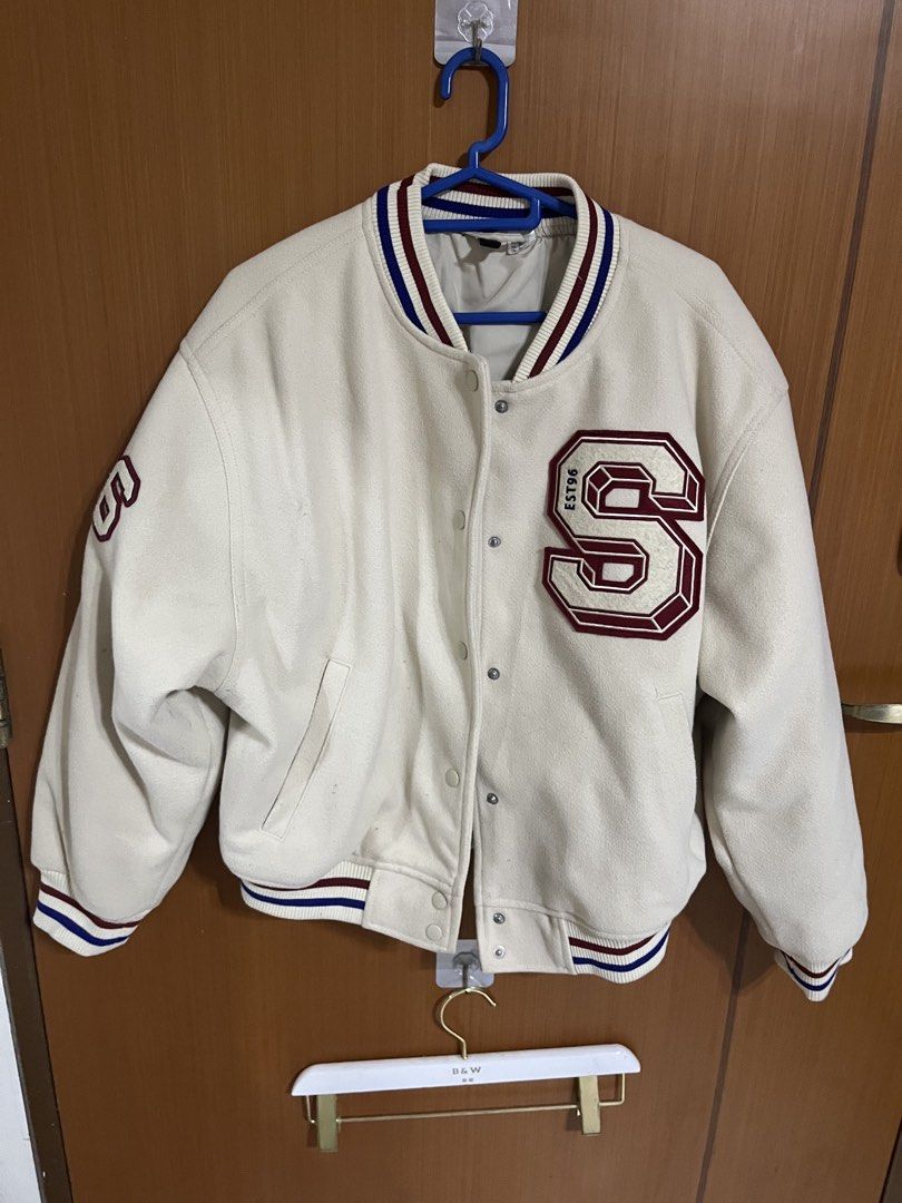 Varsity Jacket with 'S' Patch (Category: Coats, Jackets and Outerwear) located in Singapore. Submitted by lololol.cloud (Listing ID 1421423708, Image 1). Description: - Cream-colored varsity jacket - Features a large 'S' patch - '26' on the sleeve - Striped collar, cuffs, and hem - Snap button closure - Perfect for a casual, sporty look bought for about 100+ dollars in h&m thick material (help to keep cold).