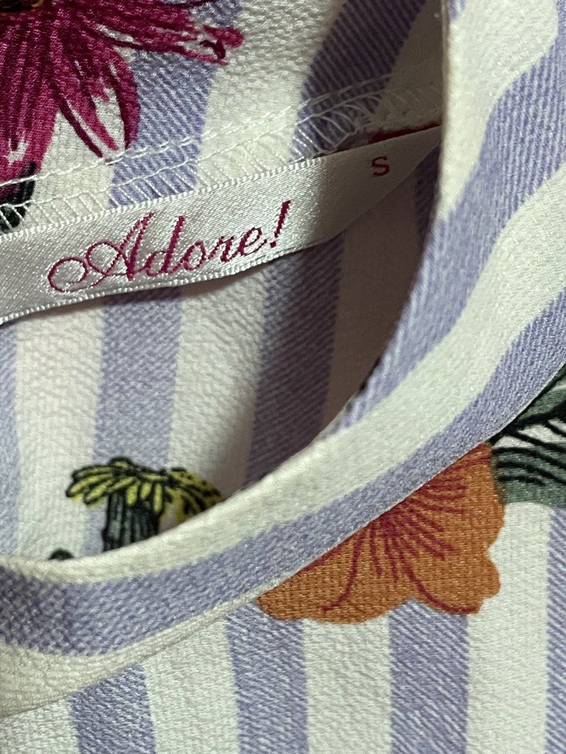 Adore Floral Striped Sleeveless Top (Category: Sleeveless) located in Infanta. Submitted by chokimon (Listing ID 1421603998, Image 2). Description: Size: S on tag but runs big Bust: 38 to 39 inches Length: 27 inches -Colorway: Stripes white and lilac - Style: Sleeveless top - Design: Floral print with cactus and flower motifs - Features: Striped pattern, high neckline, tie detail at the back.