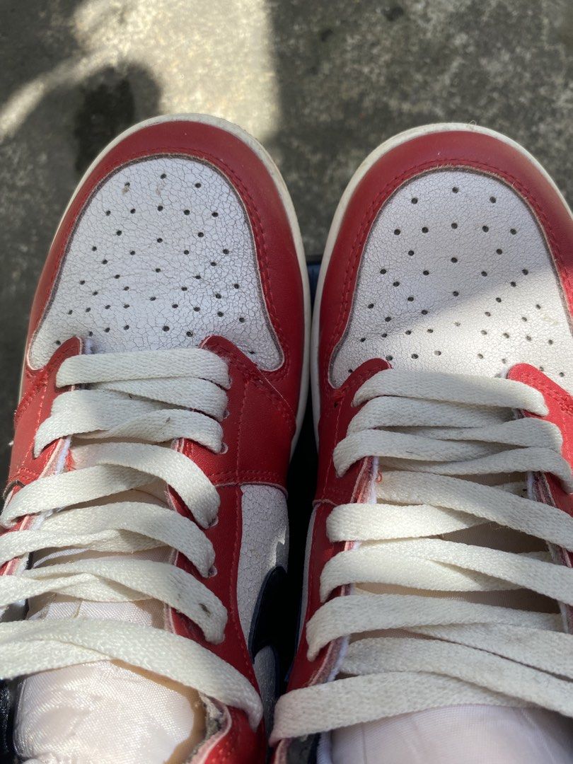 Air Jordan 1 Retro High OG (Category: Sneakers) located in Bacolod City. Submitted by 0411a (Listing ID 1421618119, Image 2). Description: Classic Air Jordan 1 Retro High OG sneakers. Features a red, white, and black colorway with the iconic Nike swoosh. The shoes have a high-top design with a padded collar. The soles show some wear. Made in Vietnam. thrifted so declared as off/legit.