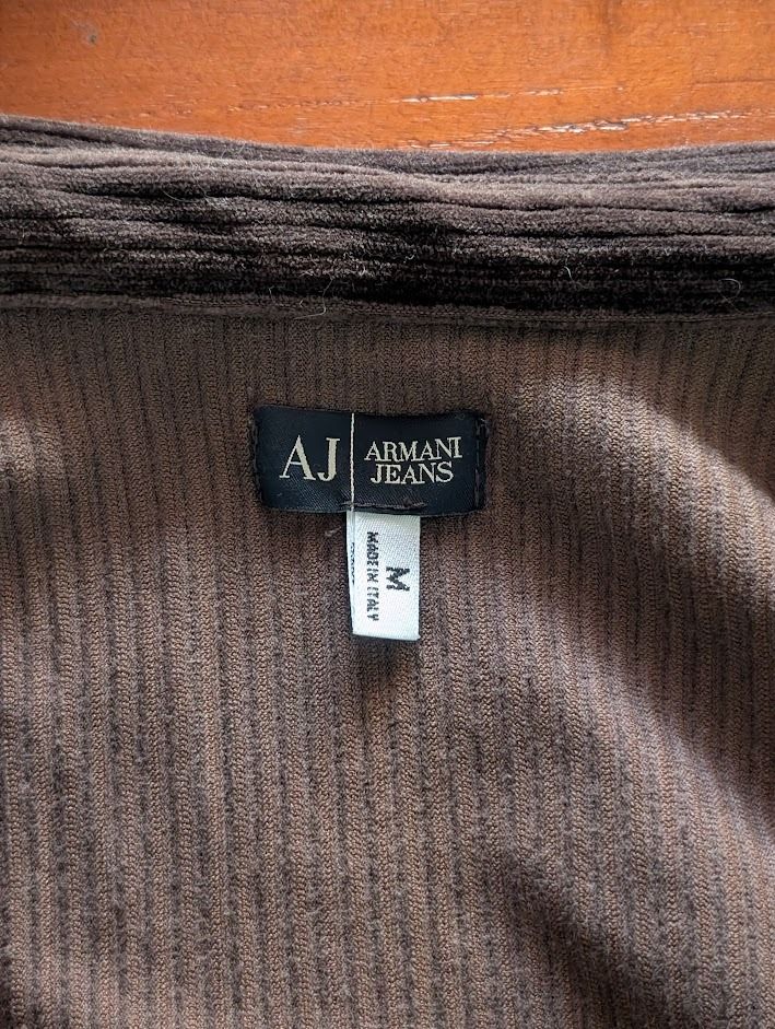 Armani Jeans Brown Corduroy Button Down Polo (Category: Tshirts & Polo Shirts ) located in Manila. Submitted by fromsiah (Listing ID 1421565225, Image 3). Description: Pre-owned Armani Jeans Brown Corduroy Button Down Polo SIZE: Medium on tag DIMENSIONS: Width - 20.5in Length - 23.5in CONDITION: 9.5/10 ISSUE: Signs of alteration Color may vary due to lighting.