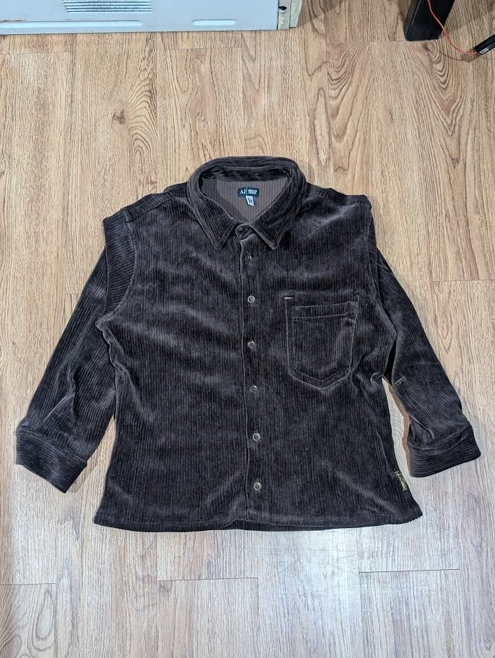 Armani Jeans Brown Corduroy Button Down Polo (Category: Tshirts & Polo Shirts ) located in Manila. Submitted by fromsiah (Listing ID 1421565225, Image 2). Description: Pre-owned Armani Jeans Brown Corduroy Button Down Polo SIZE: Medium on tag DIMENSIONS: Width - 20.5in Length - 23.5in CONDITION: 9.5/10 ISSUE: Signs of alteration Color may vary due to lighting.