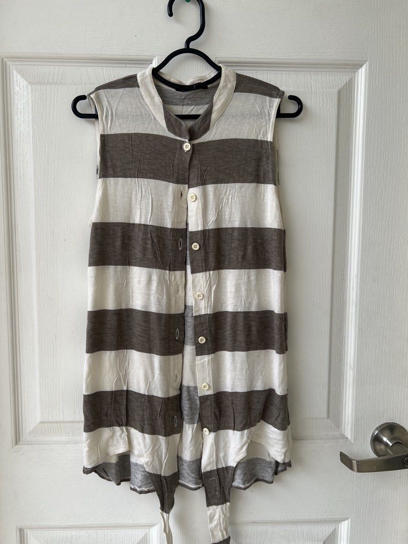 Black Sheep Striped Sleeveless Top (Category: Sleeveless) located in Quezon City. Submitted by millevlrd_ (Listing ID 1421510888, Image 1). Description: - Black Sheep sleeveless top - Size: Small - Design: White and brown stripes - Features: Button-down front, mandarin collar, tie detail at the bottom - Style: Casual wear.