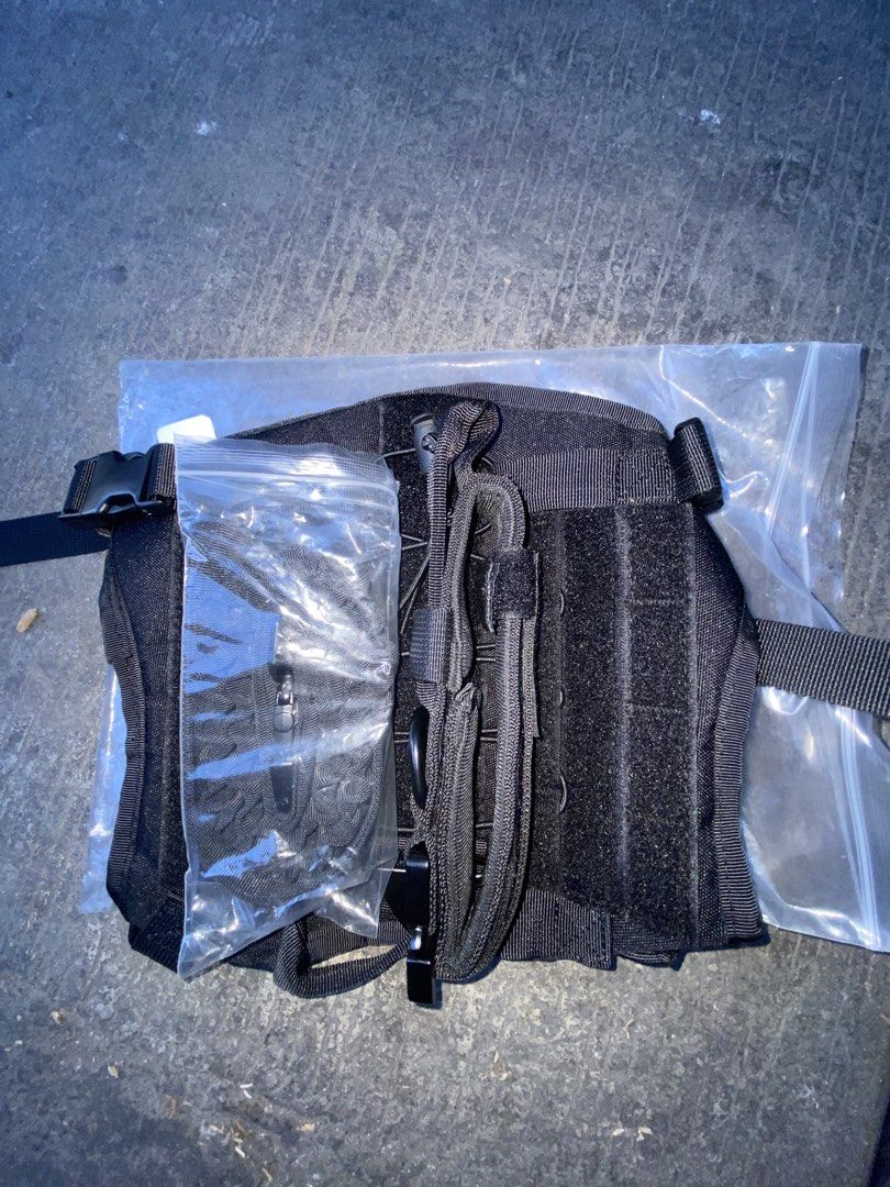 Black Tactical Vest (Category: Vests) located in Caloocan City. Submitted by younghov888 (Listing ID 1421524477, Image 1). Description: - Black tactical vest - Multiple pouches and compartments - Includes extra components - Adjustable straps and buckles - Durable, heavy-duty material.