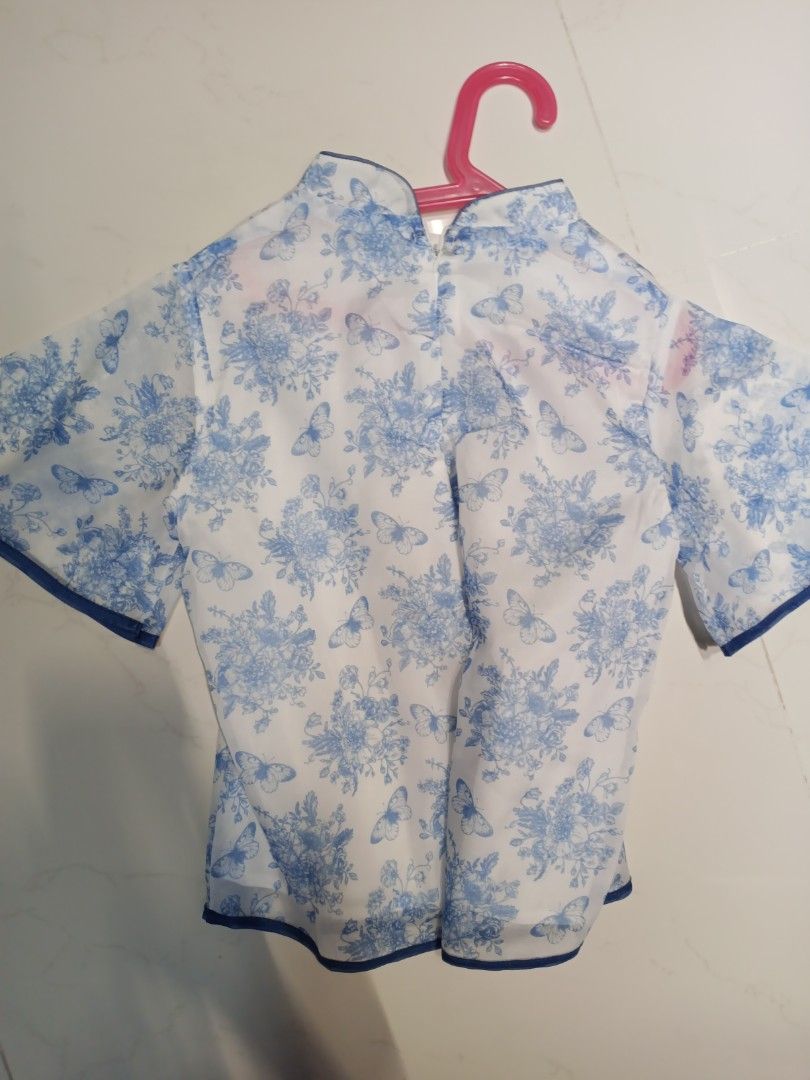 Chinese new year top (Category: Babies & Kids Fashion) located in Singapore. Submitted by monchichilover (Listing ID 1421539931, Image 2). Description: - Adorable baby girl's top - Features a lovely floral and butterfly print - Stylish mandarin collar - Cute tie detail - Perfect for special occasions or everyday wear.