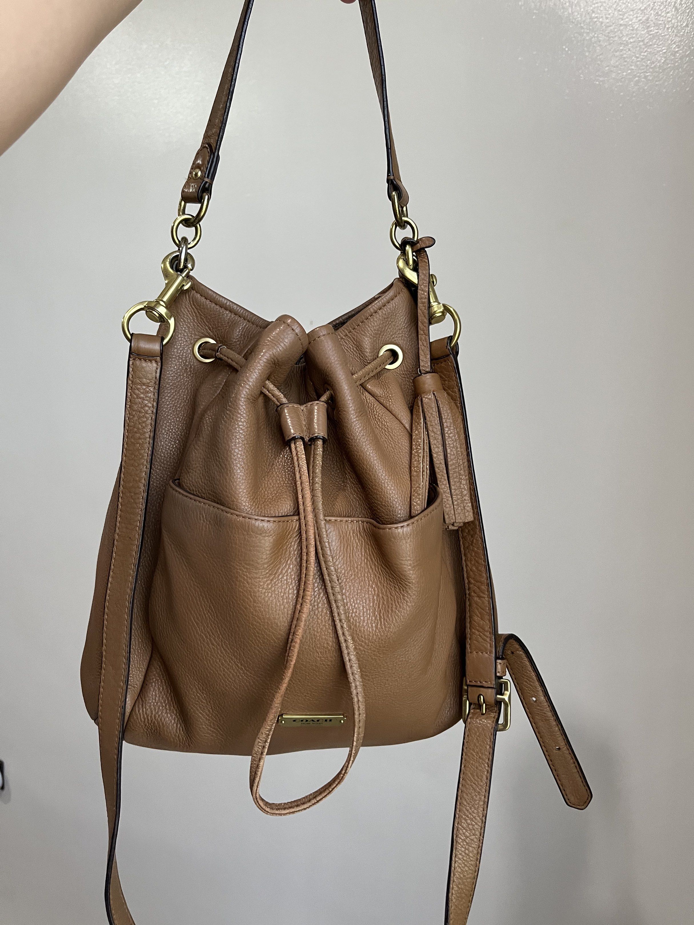 Coach Avery Leather Drawstring Bucket Bag (Category: Luxury Bags & Wallets) located in Bacolod City. Submitted by gin.knee (Listing ID 1421490151, Image 1). Description: - Coach drawstring bucket bag - Brown color - Drawstring closure - Adjustable shoulder strap - Exterior pocket - Interior zippered pocket - Gold-tone hardware ❌ With fading on hardware.