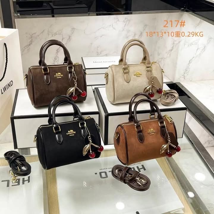Coach Mini Cylinder Handbag (Category: Luxury Bags & Wallets) located in Manila. Submitted by raredeer-4deb4e (Listing ID 1421505049, Image 3). Description: - Mini cylinder handbag - Top handle & detachable shoulder strap - Cherry charm & Coach logo - Available colors: Black, Brown, Beige - Dimensions: Approx. 18cm x 13cm x 10cm - Weight: 0.29kg.