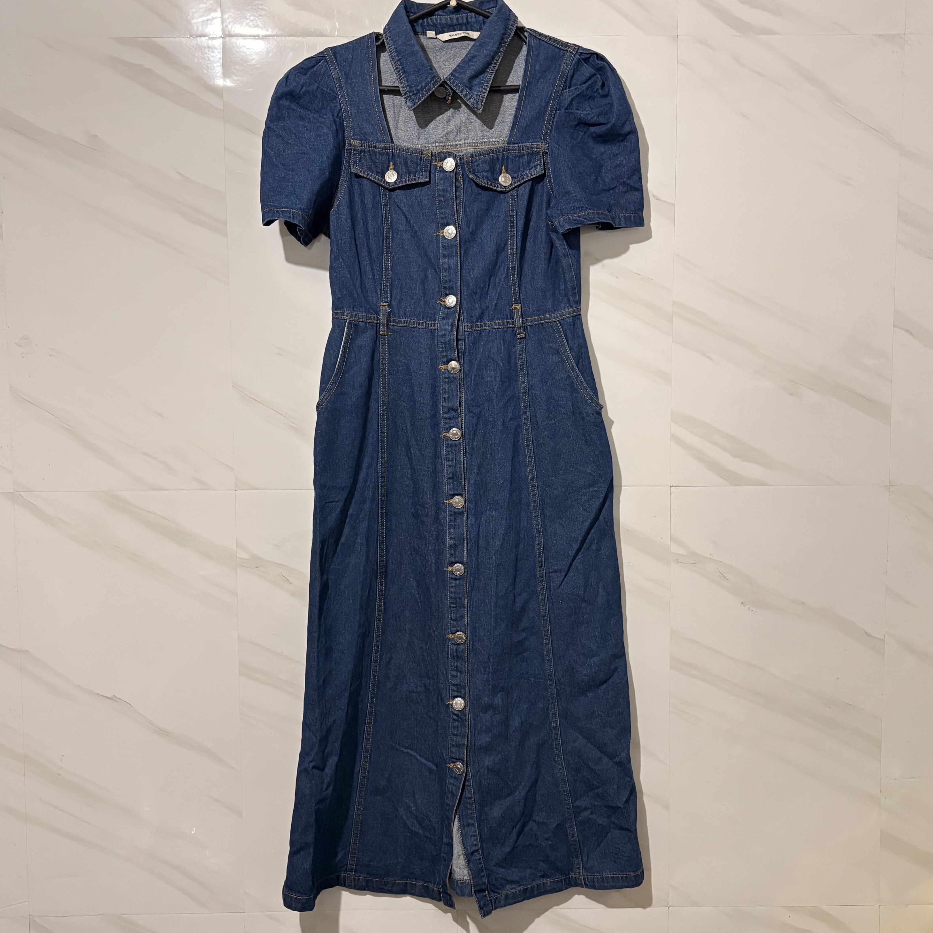Denim Dress with Puff Sleeves (Category: Dresses) located in Tarlac. Submitted by shantirisque (Listing ID 1421511541, Image 1). Description: size: med on tag but can fit up to small only bust: 34 waist: 26-27 length: 48.5 inches from shoulder to bottom Denim dress features a unique square neckline and puff sleeves. It has a button-down front and a midi length. The dress has a collared neckline and pockets. The back of the dress has a tailored de