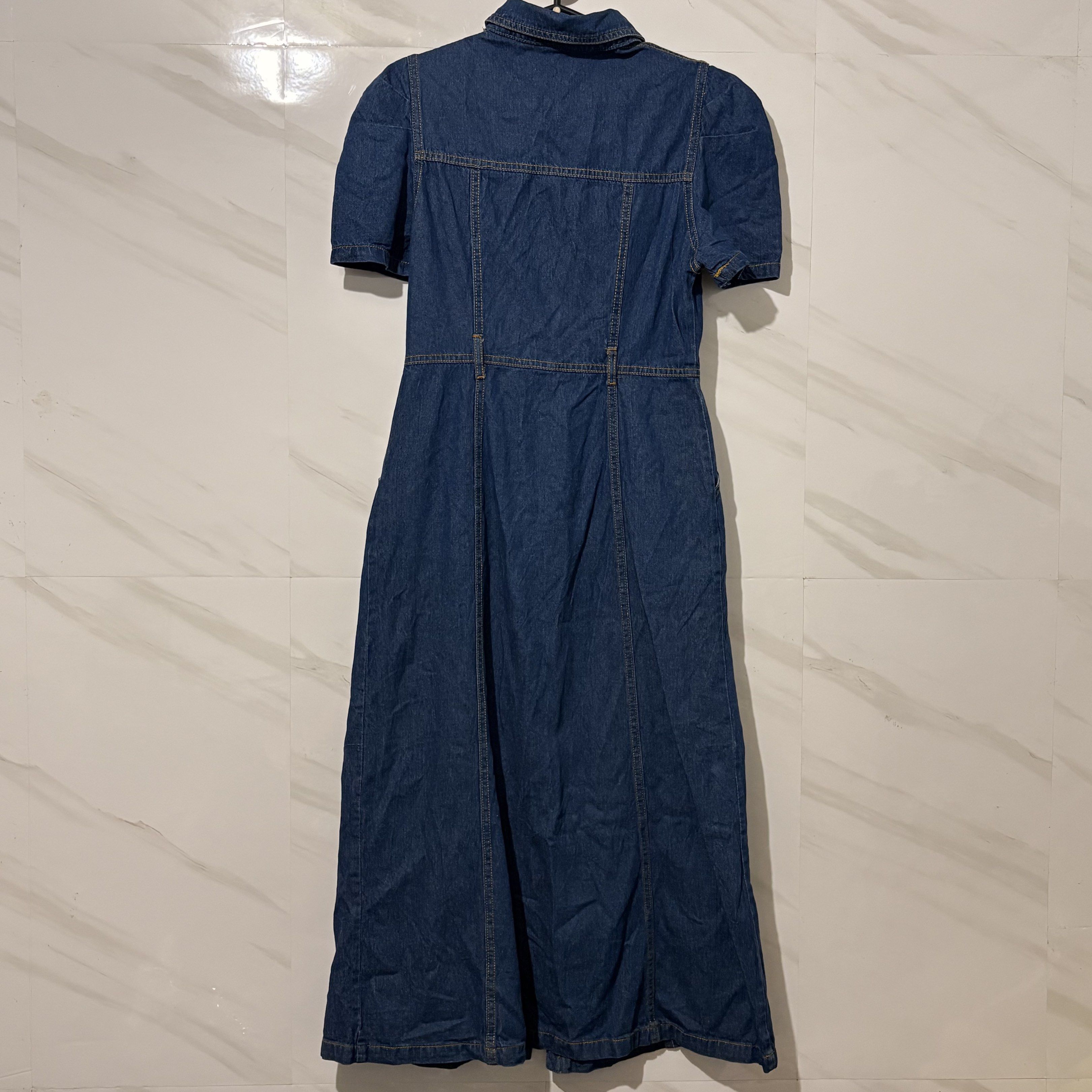 Denim Dress with Puff Sleeves (Category: Dresses) located in Tarlac. Submitted by shantirisque (Listing ID 1421511541, Image 3). Description: size: med on tag but can fit up to small only bust: 34 waist: 26-27 length: 48.5 inches from shoulder to bottom Denim dress features a unique square neckline and puff sleeves. It has a button-down front and a midi length. The dress has a collared neckline and pockets. The back of the dress has a tailored de