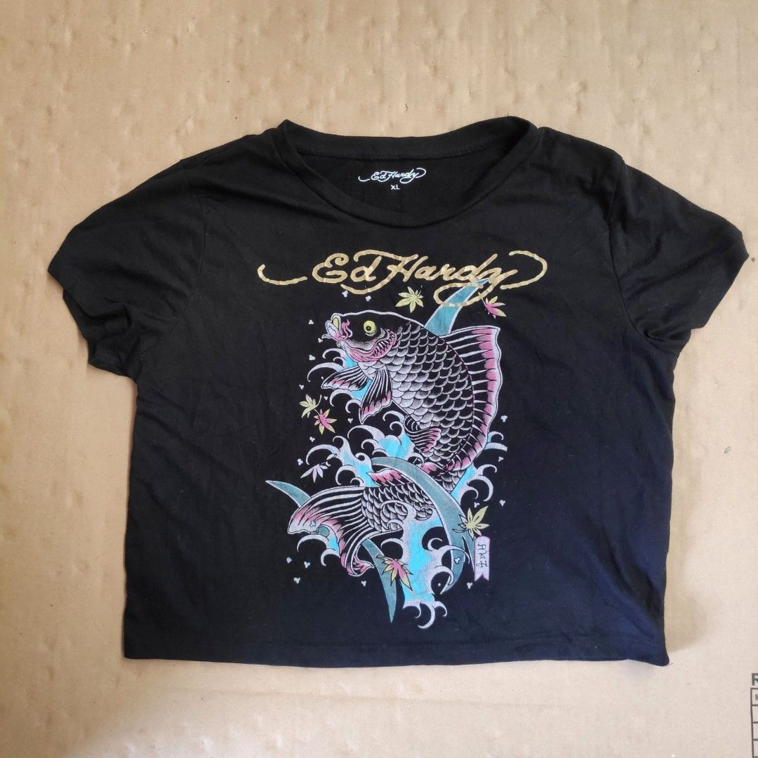 Ed Hardy Black Fish Graphic Cropped Tee XL (Category: Shirts) located in Masbate. Submitted by ydruattacks (Listing ID 1421461185, Image 1). Description: - Ed Hardy t-shirt - Black color - Features a fish graphic on the front - Brand name on the back - Crew neck and short sleeves - Size: XL - Material: 65% polyester, 35% cotton - Style: EHW1104.