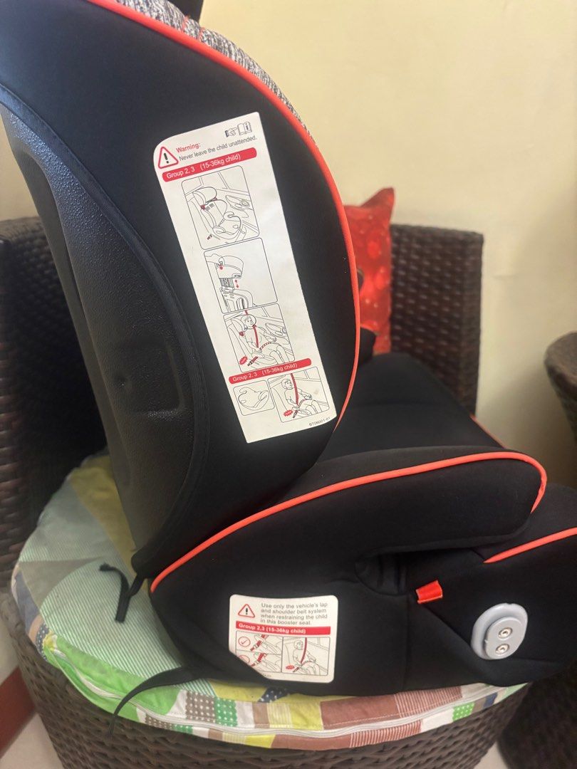 Evenflo Booster Car Seat (Category: Car Seats) located in Manila. Submitted by jrlua (Listing ID 1421565613, Image 2). Description: Evenflo booster car seat for Group 2,3 (15-36kg child). Features a black and grey seat with orange accents. Includes a seat belt guide. The seat has a headrest and side supports. The seat is designed to be used with the vehicle's lap and shoulder belt system. .