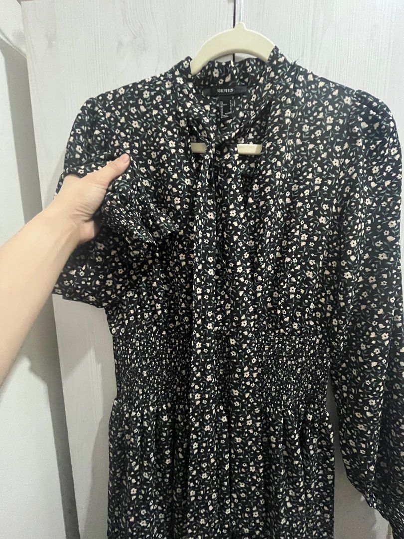 Forever 21 Floral Dress (Category: Dresses) located in Makati City. Submitted by joycesp (Listing ID 1421508763, Image 2). Description: - Forever 21 dress - Black base with floral pattern - Long sleeves with ruffled cuffs - High neckline with tie detail - Fitted bodice, flowing skirt - Lightweight fabric.